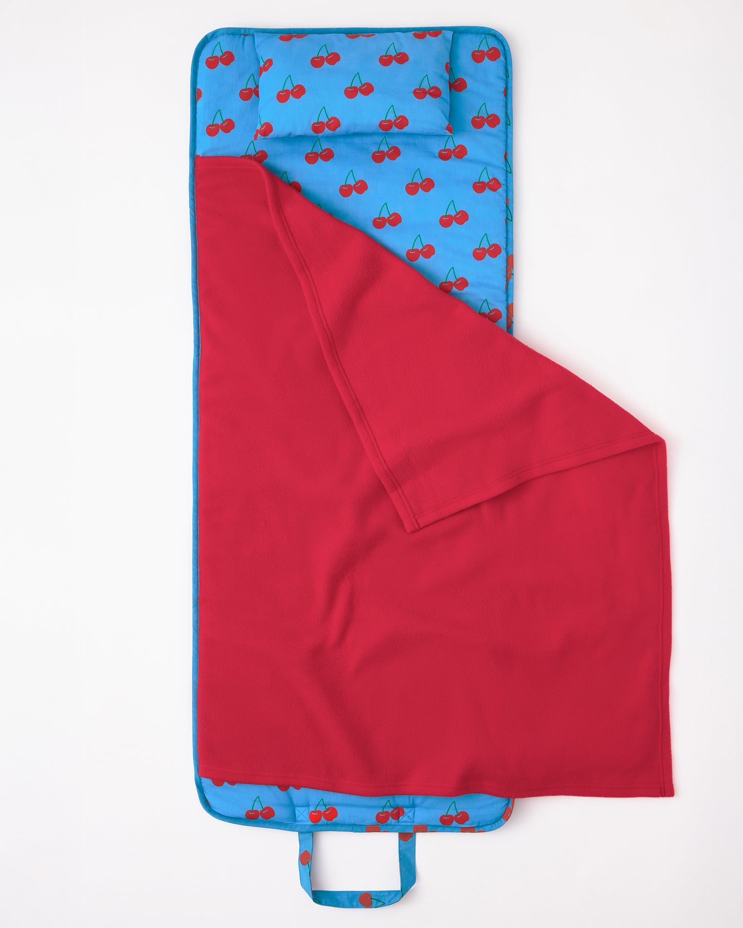 The Nap Mat in Blue Cherries pattern on a beige background.