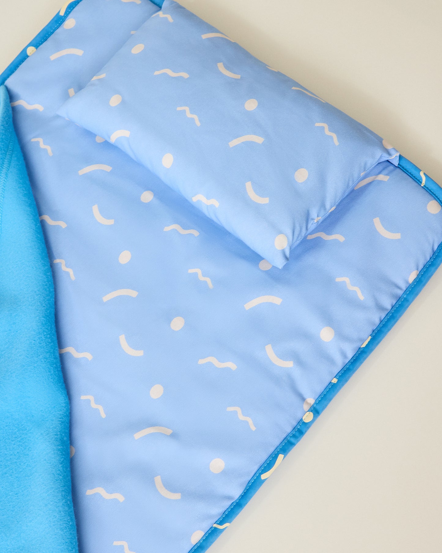 Nap Mat in and sky squiggles pattern with matching pillow on beige background
