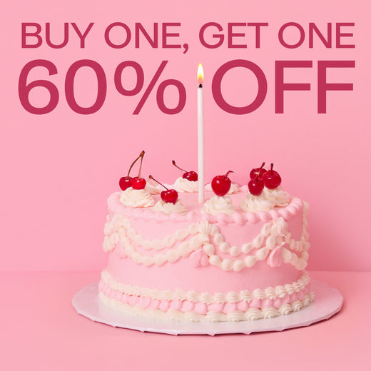 Pink cake with cherries and a candle on a pink background with promotional text.
