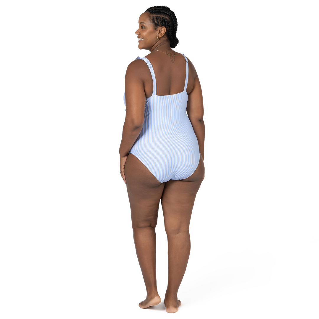 Back of a model wearing the Ruffle Wrap Maternity & Nursing One Piece Swimsuit in Coastal Stripe