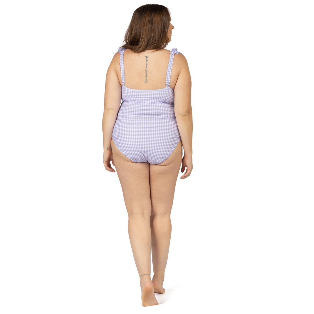 Back view of a model wearing the Ruffle Wrap Maternity & Nursing One Piece Swimsuit in Lavender Gingham