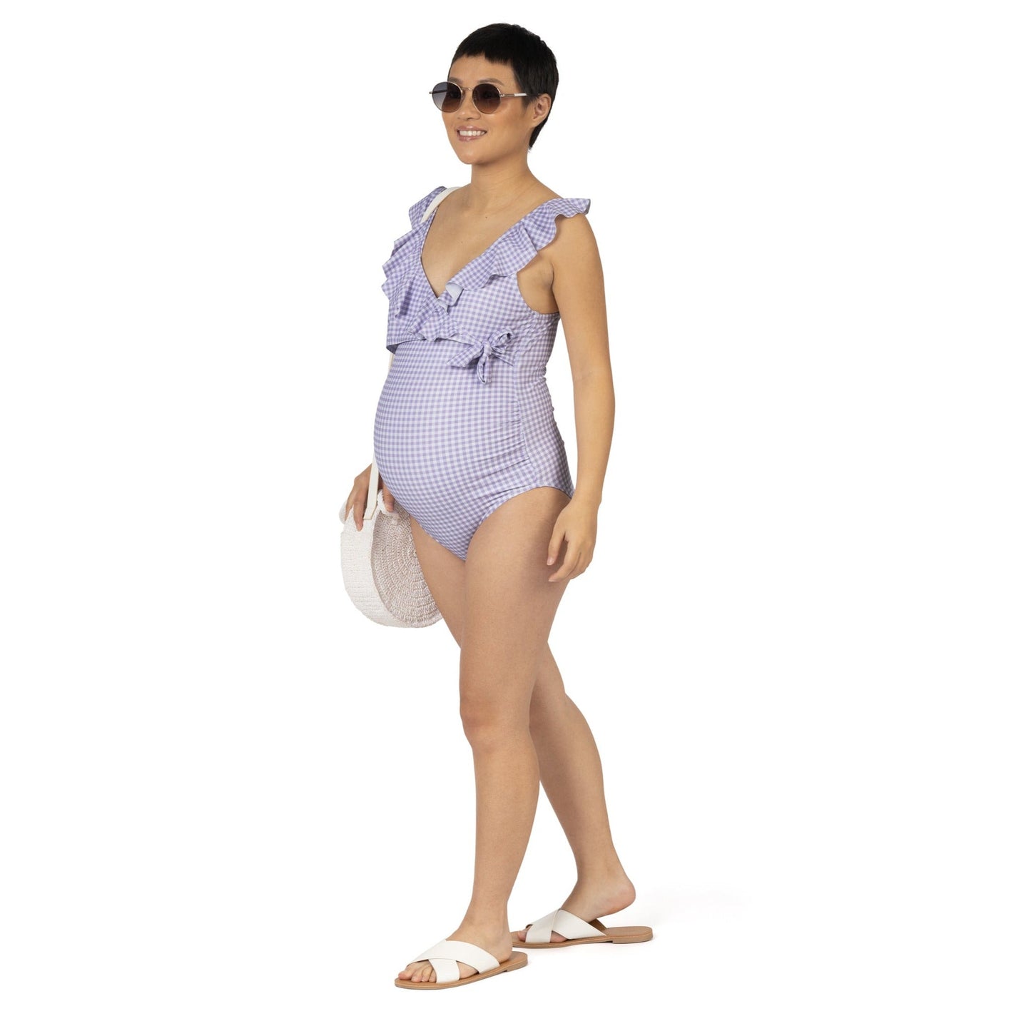 Pregnant model wearing the Ruffle Wrap Maternity & Nursing One Piece Swimsuit in Lavender Gingham @model_info:Lan is wearing a Small Regular.