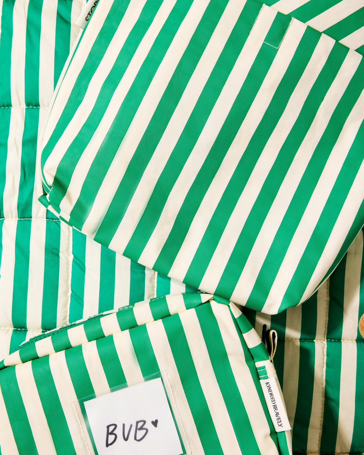 Close up of set of green and white striped bags and mat
