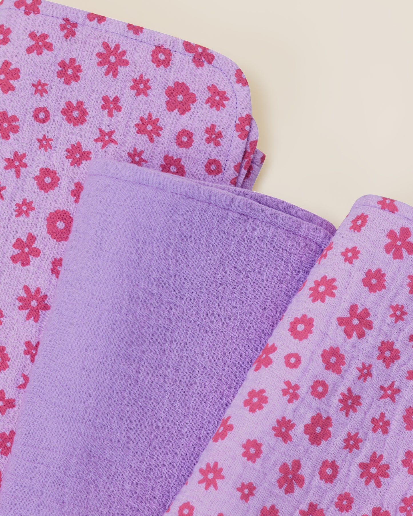 Close up of the set Organic Muslin Burp Cloth in Lavender Cosmos print.