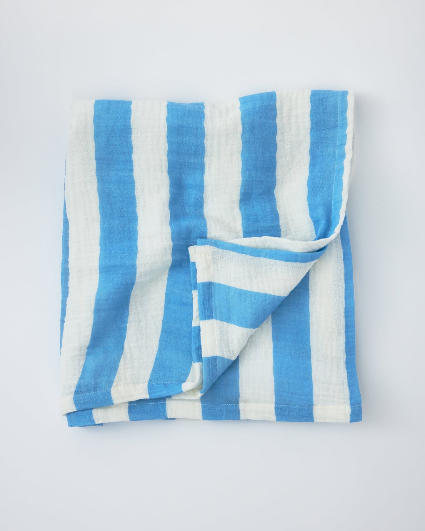 Organic Muslin Burp Cloth (Three-Pack) in Blue Wide Stripe on a beige background.