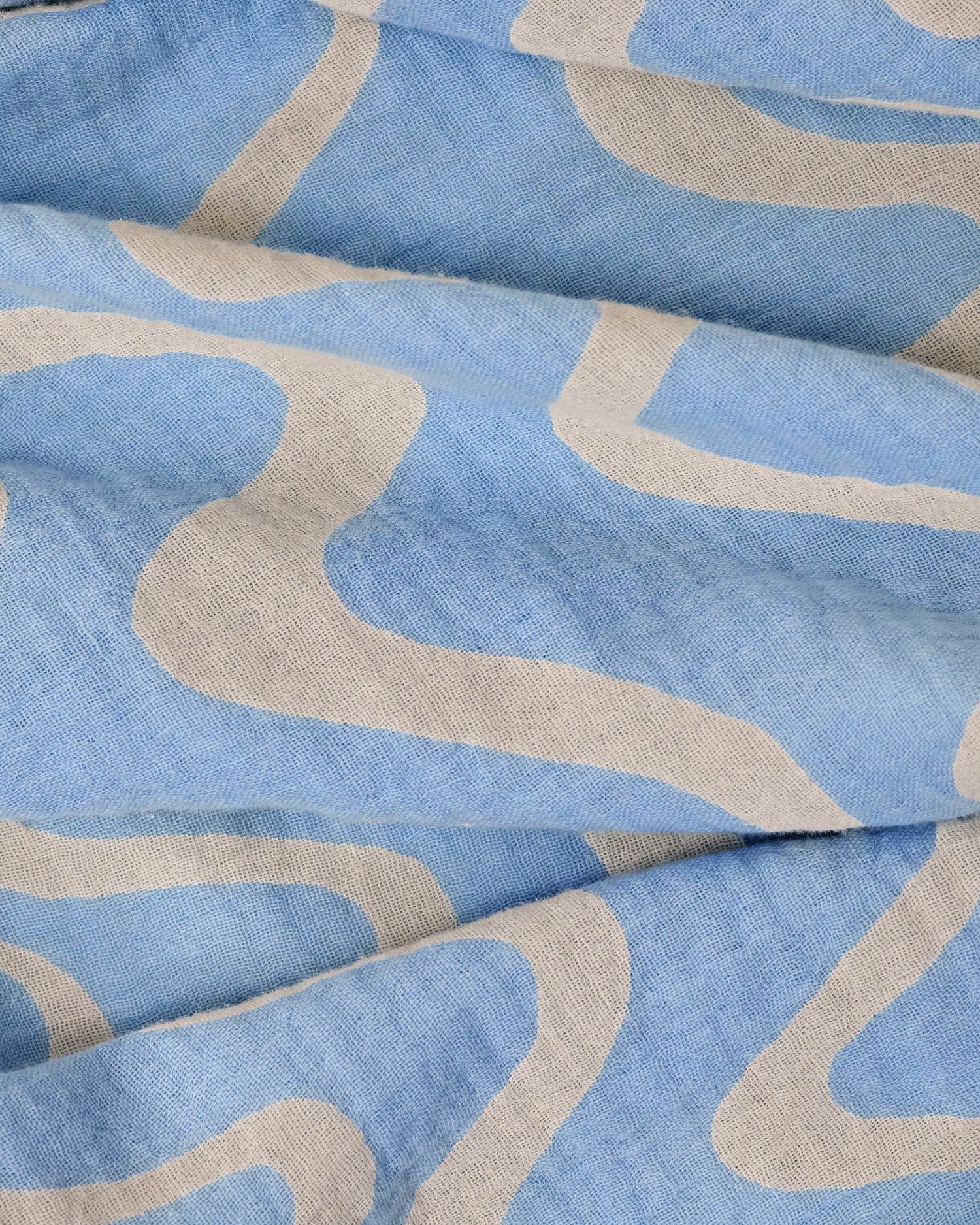 Close up of the Organic Muslin Swaddle in the Blue Waves print.