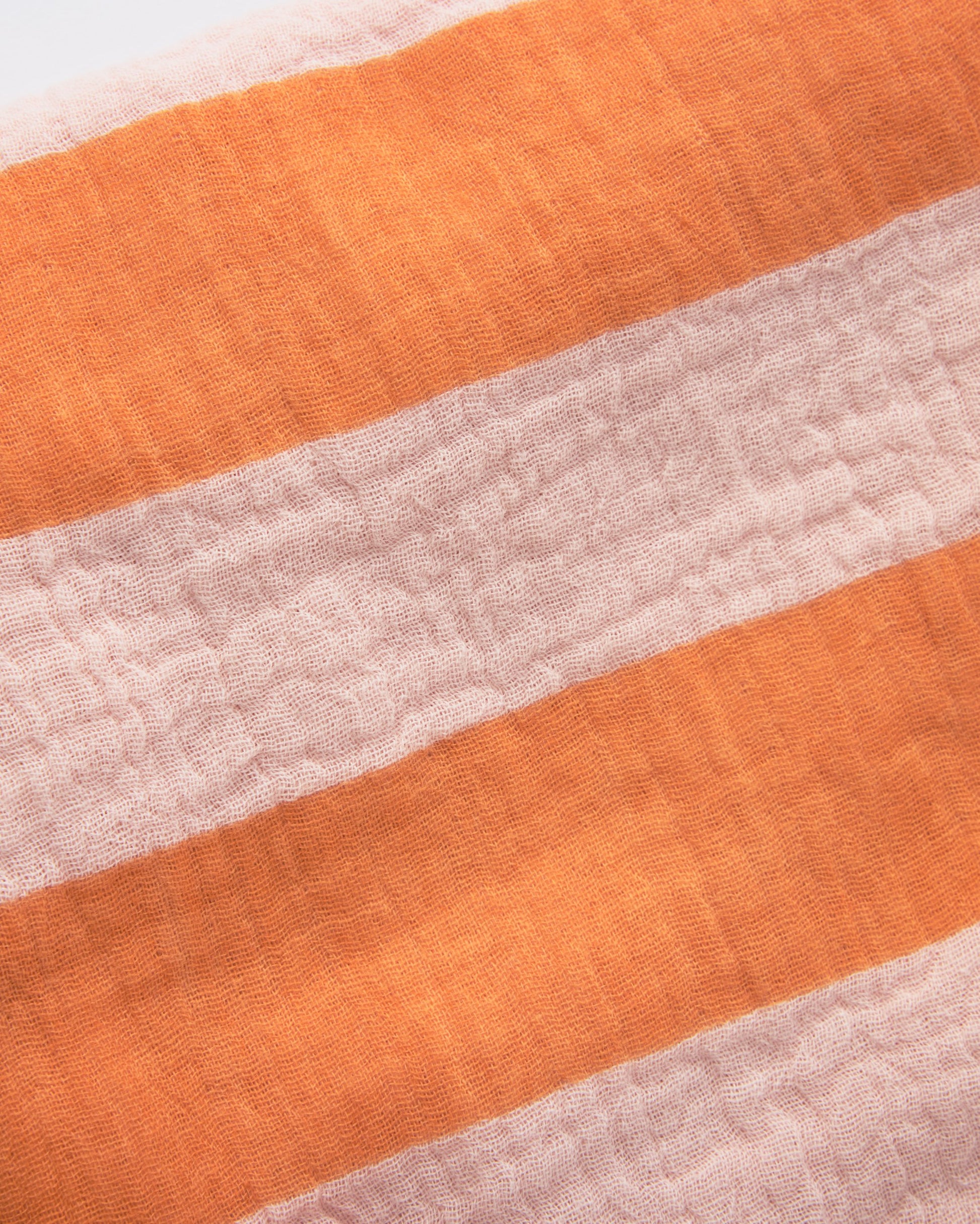 Close up of soft material of the Organic Muslin Burp Cloth (Three-Pack) in Pink Wide Stripe.