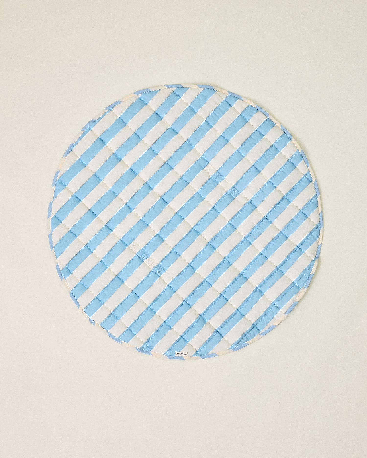 Inside/Outside Play Mat in Blue Wide Stripe with blue and white stripes on a beige background