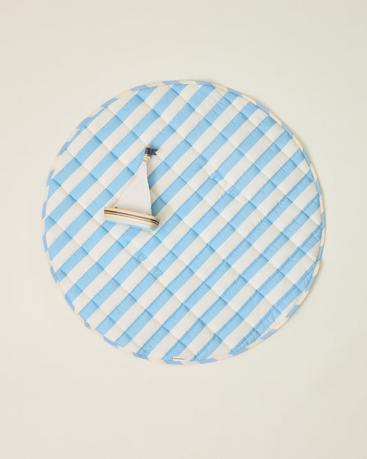 Inside/Outside Play Mat in Blue Wide Stripe with blue and white stripes with toy sailboat on a beige background
