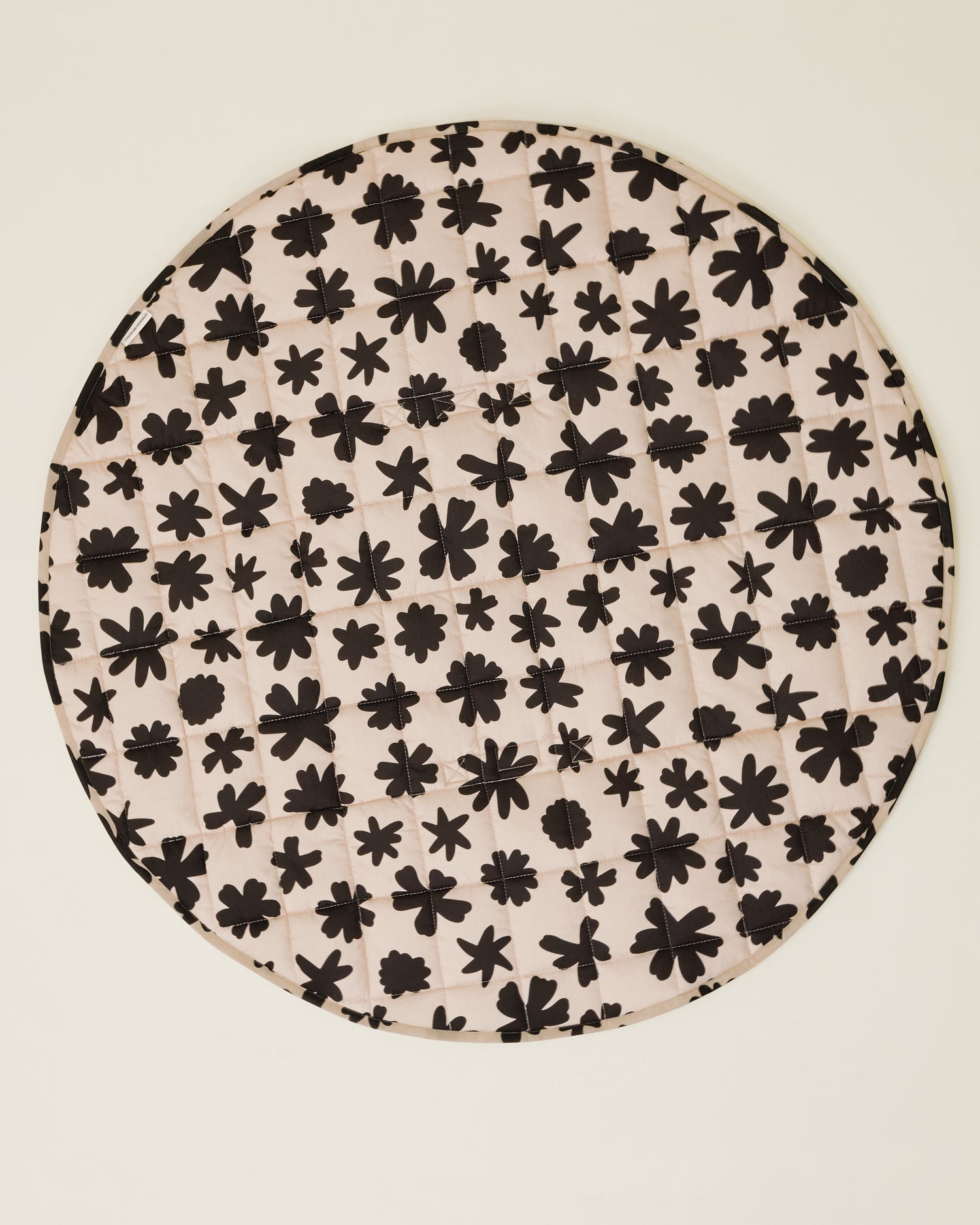 The Inside/Outside Play Mat in Cream Chamomiles print, opened fully to a circle.