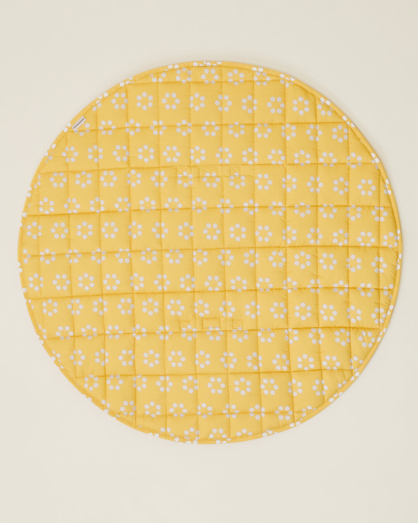 The Inside/Outside Play Mat in Sunshine Dots print, opened fully to a circle.