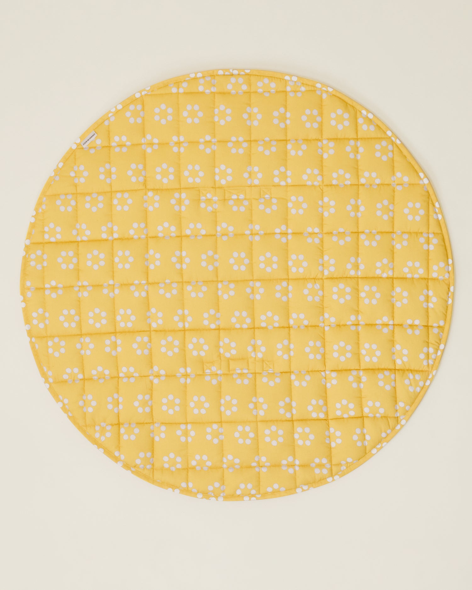 The Inside/Outside Play Mat in Sunshine Dots print, opened fully to a circle.