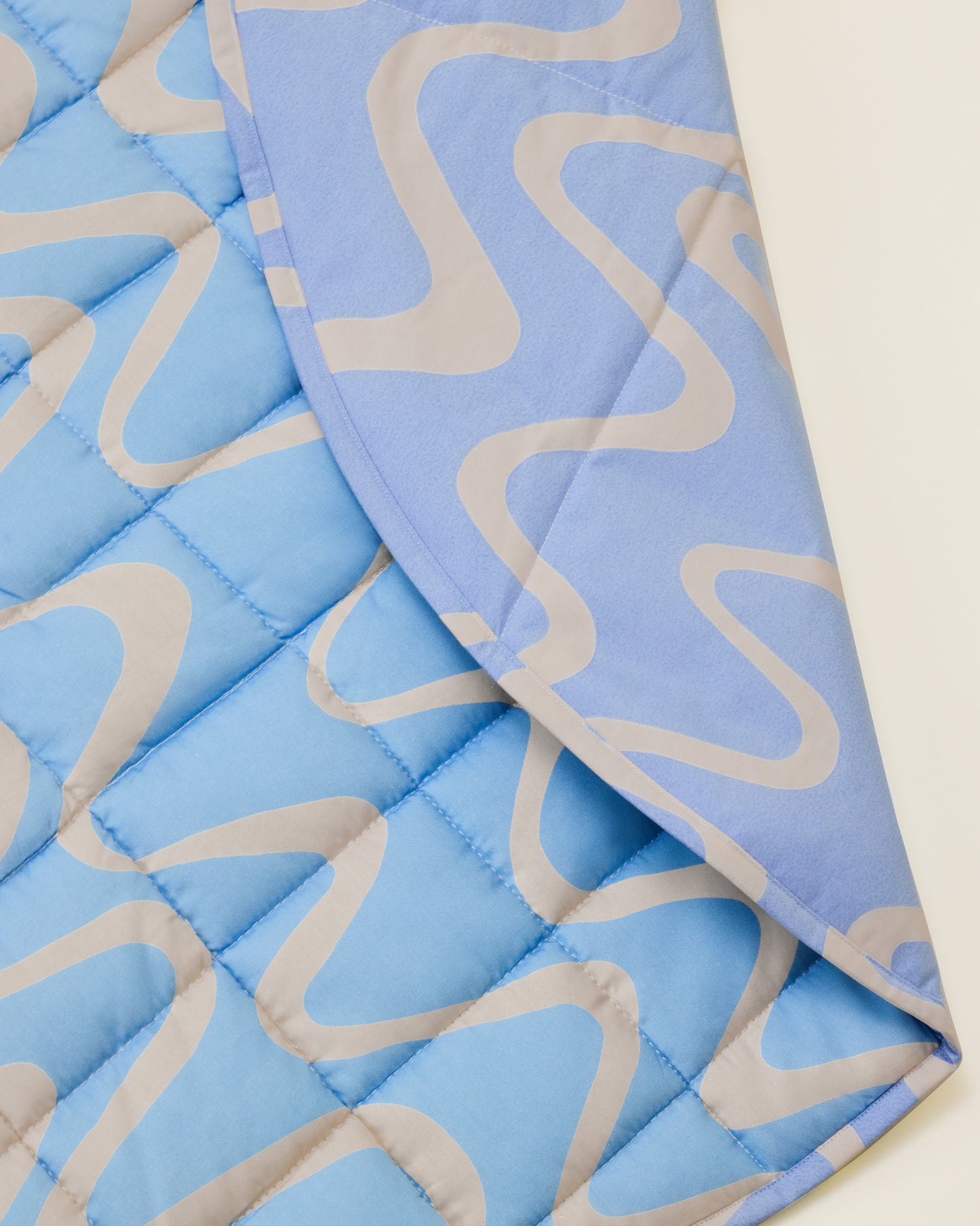 Close up of the Inside/Outside Play Mat in Blue Waves print.