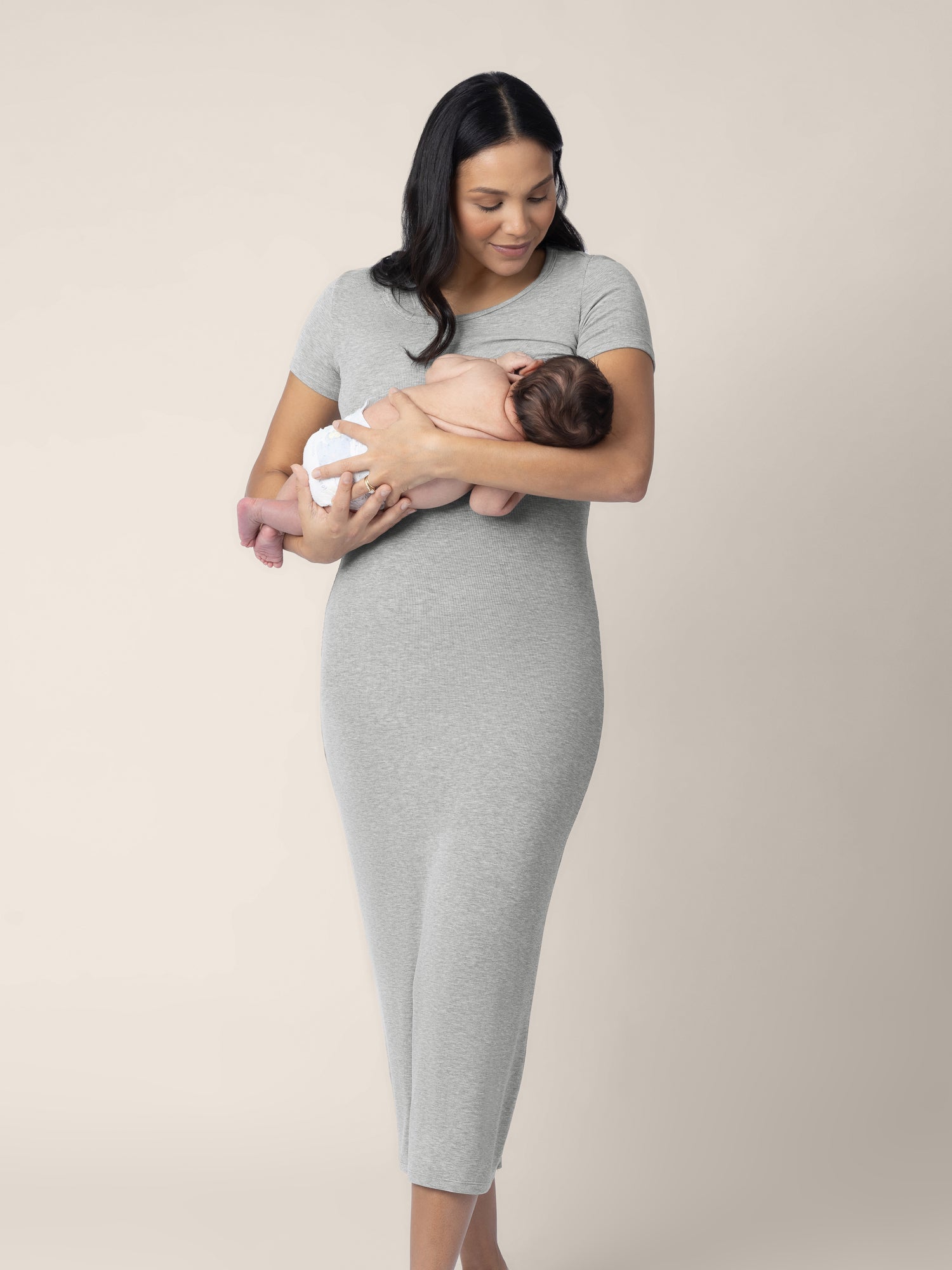 Breastfeeding model wearing the Olivia Ribbed Bamboo 2-in-1 Maternity & Nursing Dress in Grey Heather @model_info:Julana is 5'9" and wearing a Small.