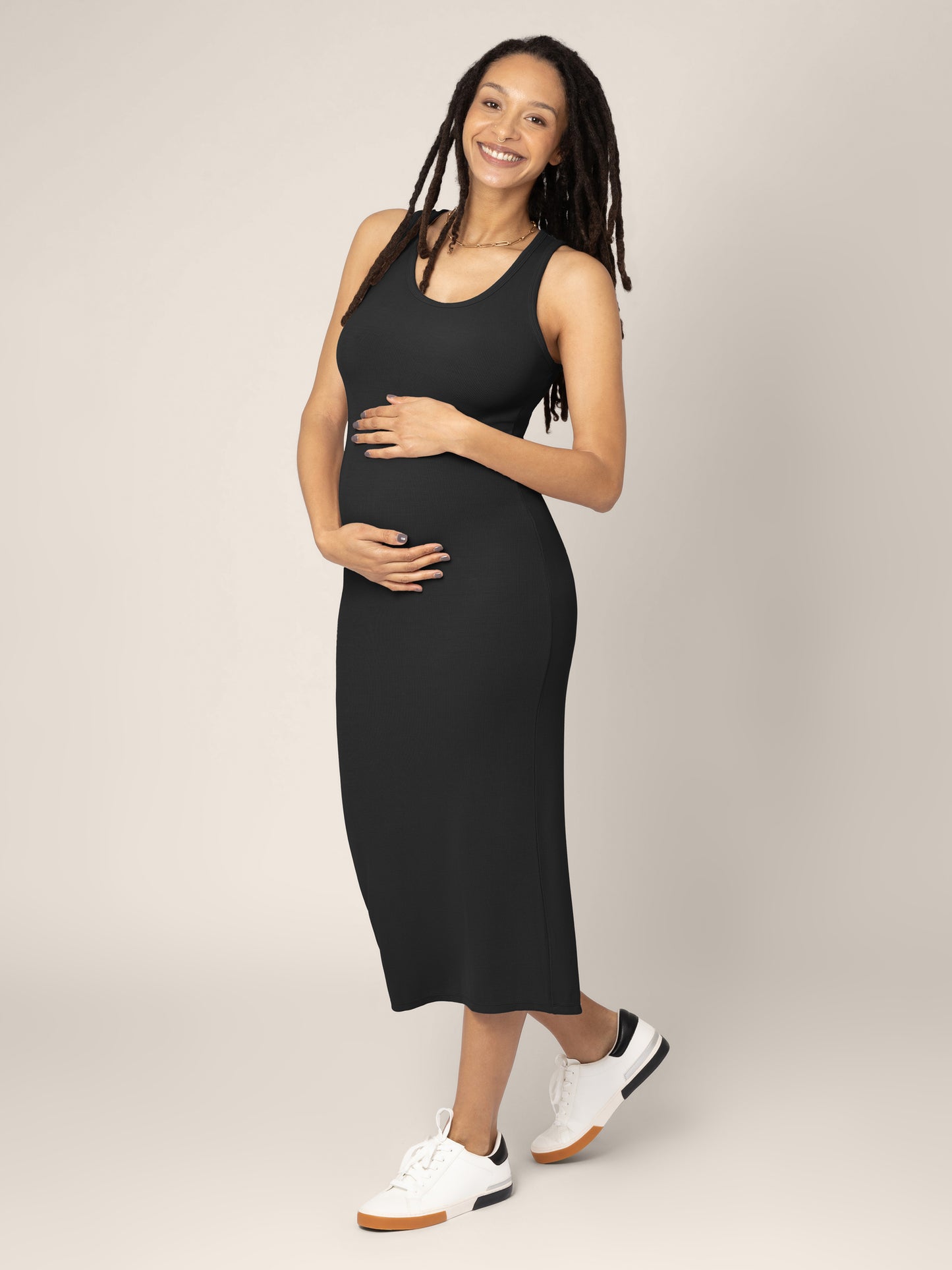 Pregnant model wearing the Olivia Ribbed Bamboo 2-in-1 Maternity & Nursing Dress in Black, showing off the tank top portion of the dress