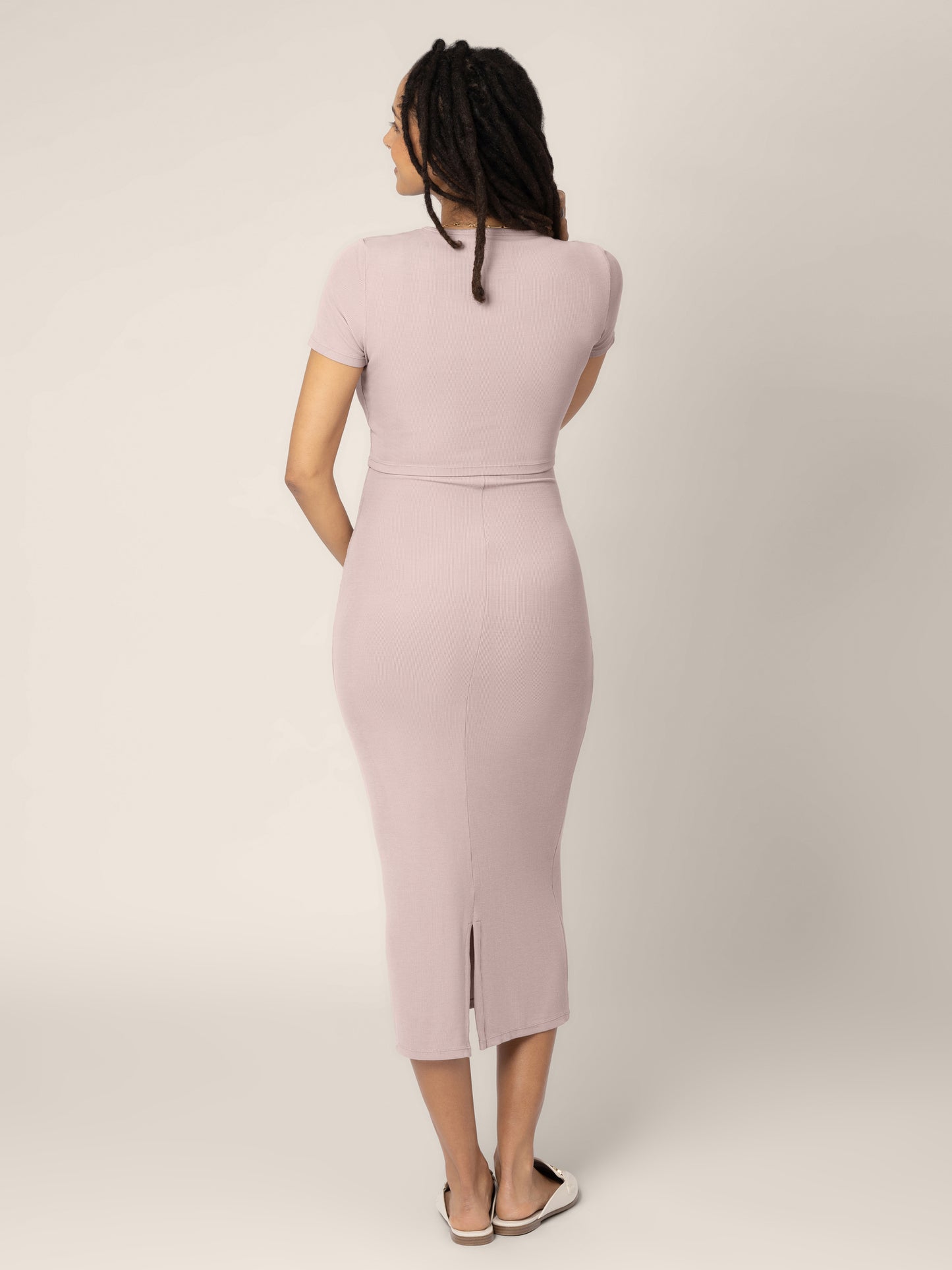 Back view of a pregnant model wearing the Olivia RIbbed Bamboo 2 in 1 Maternity & Nursing Dress in Lilac Stone.