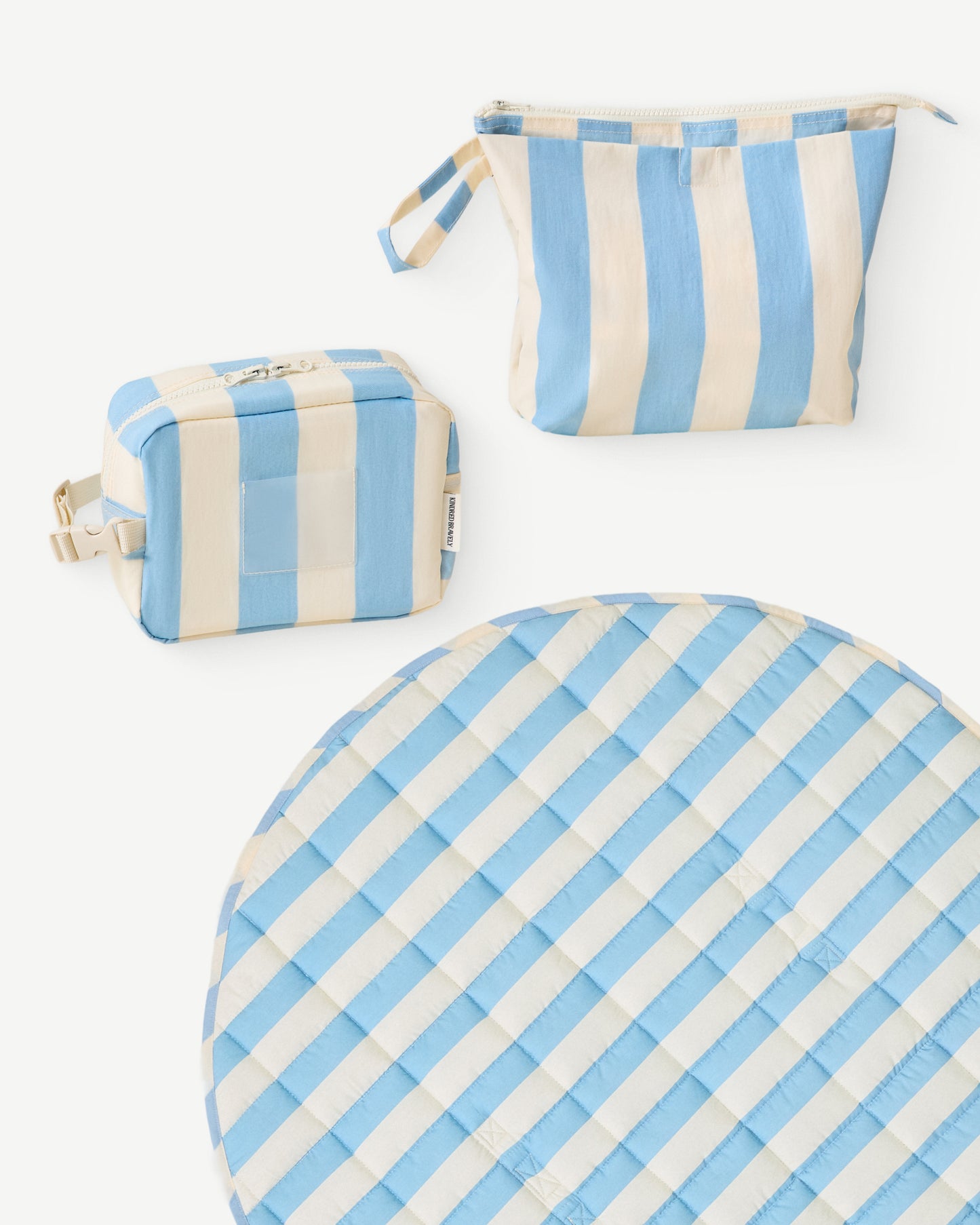 The Quick Change Kit Bag, the Mini Cooler Bag, and the Inside/Outside Play Mat  of the On the Go Bundle in Blue Wide Stripe on a white background.