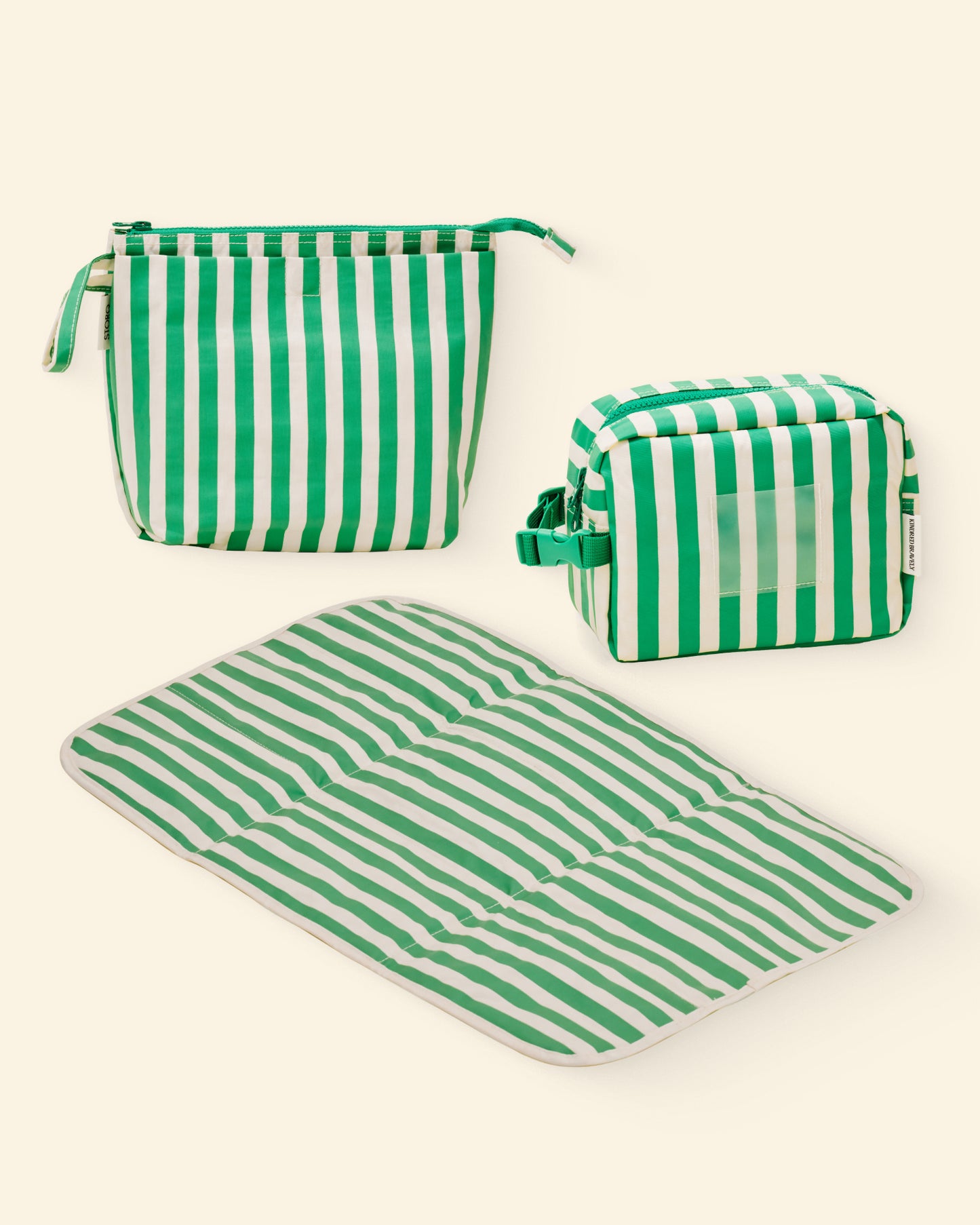 Set of green and white striped pouches and a mat on a light background