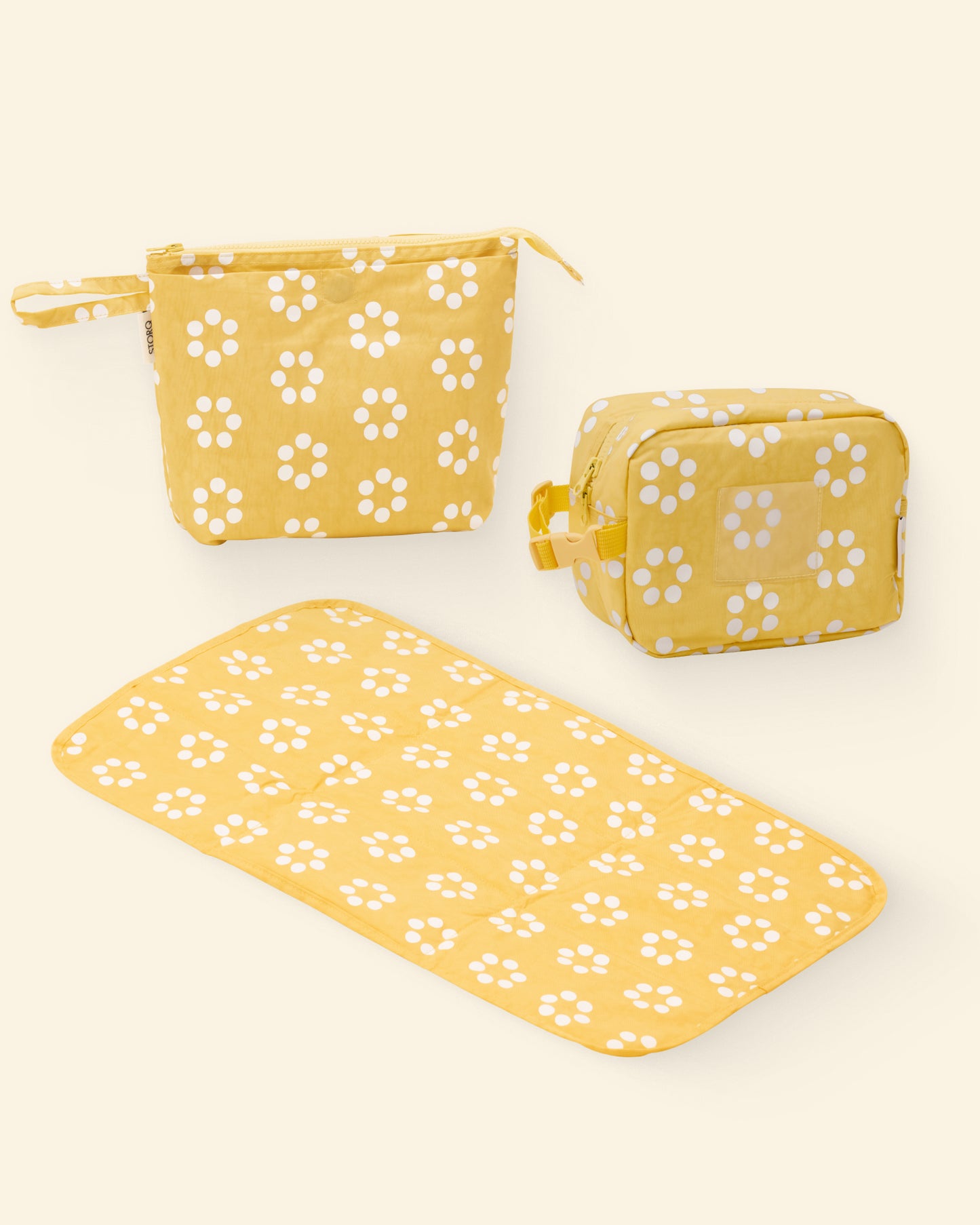Set of Yellow Sunshine Dots floral-patterned pouches and mat on a light background