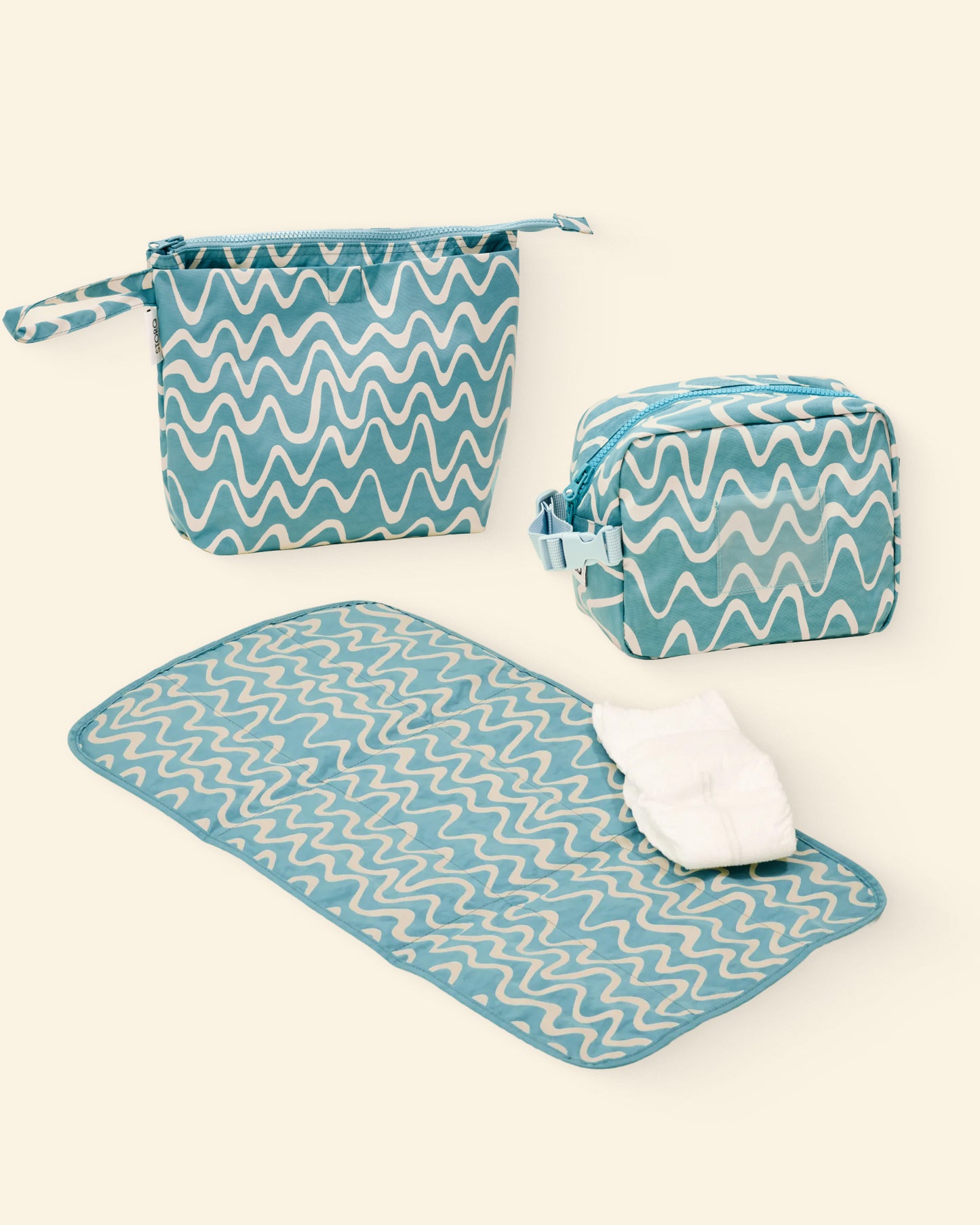 Set of blue and white wave patterned bags and a mat on a light background