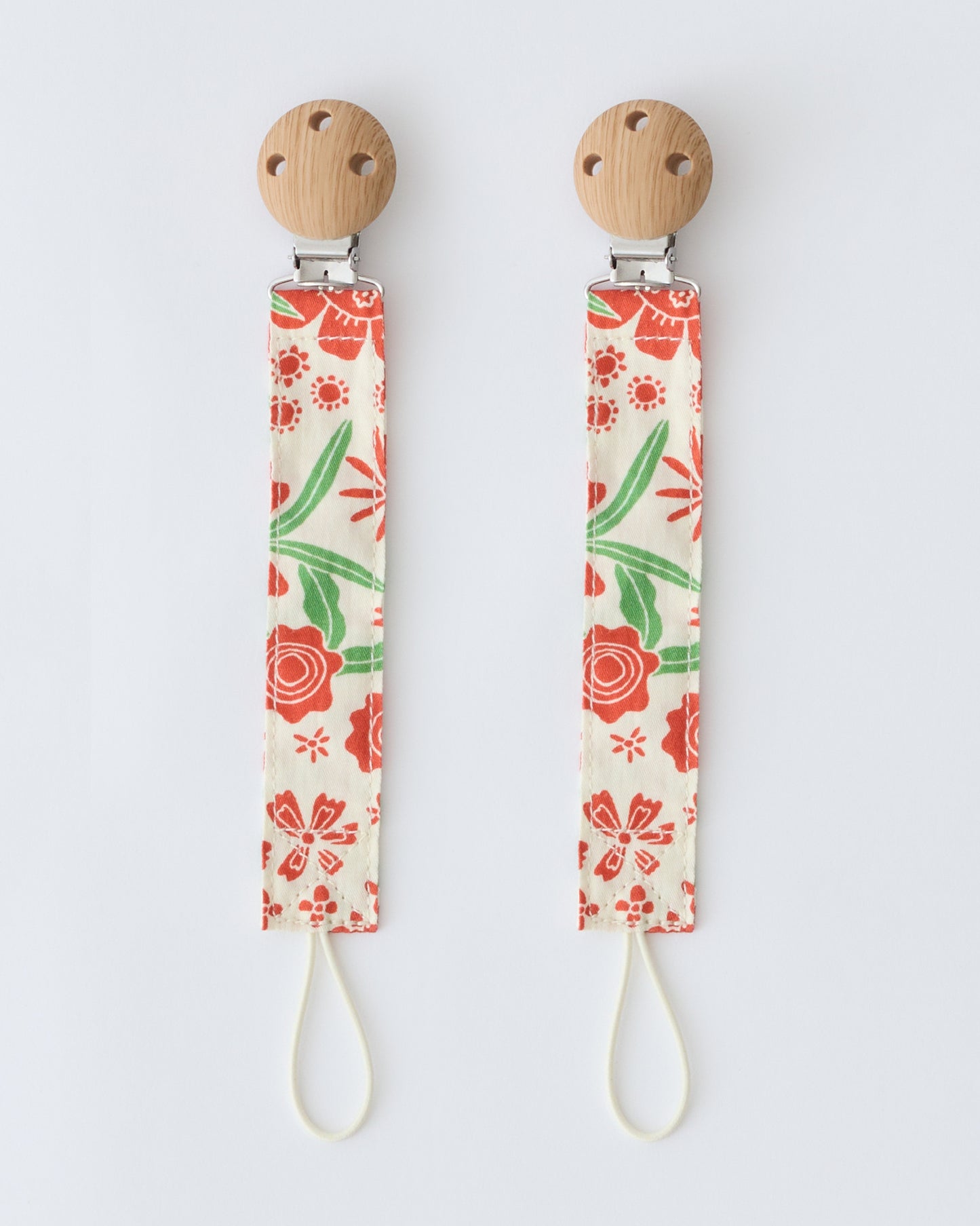 Pacifier Clip Two-Pack in Superbloom,  on a beige background.