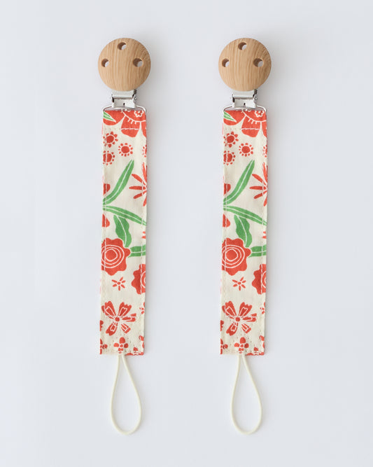 Pacifier Clip Two-Pack in Superbloom,  on a beige background.