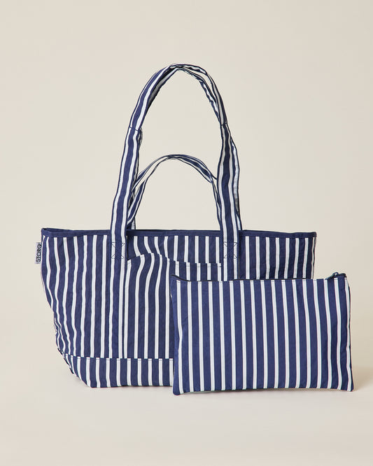 Navy blue and white striped Packable Park Carryall with included matching pouch on a beige background