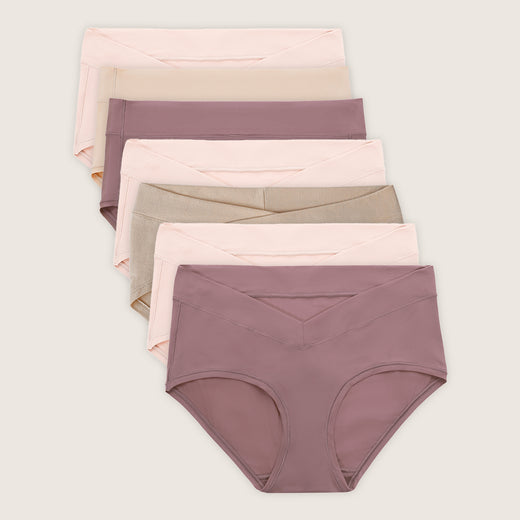 Set of women's underwear in various pastel colors on a light beige background