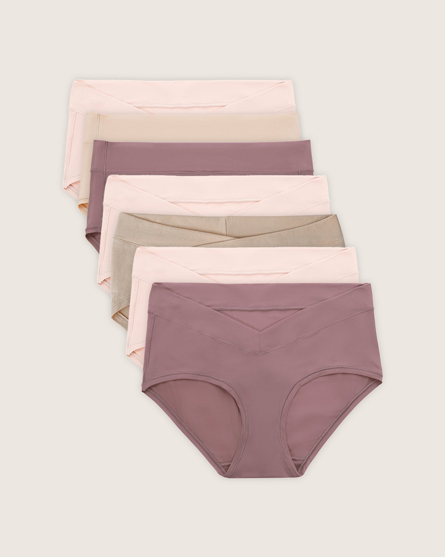 Set of women's underwear in various pastel colors on a light beige background