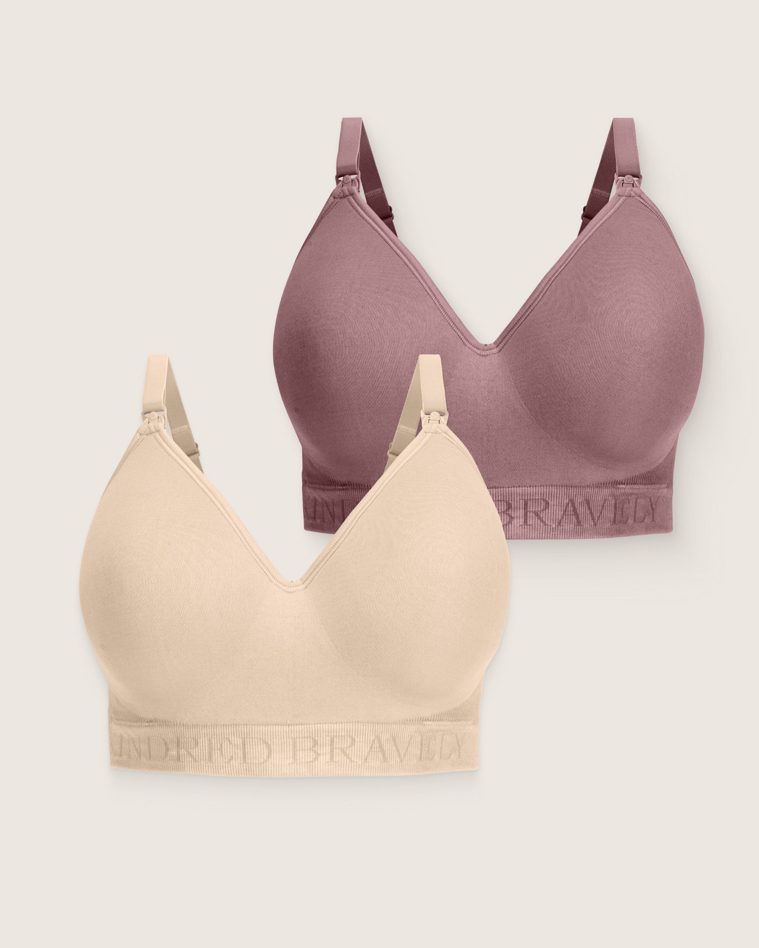 Two bras, one purple and one beige, on a light gray background