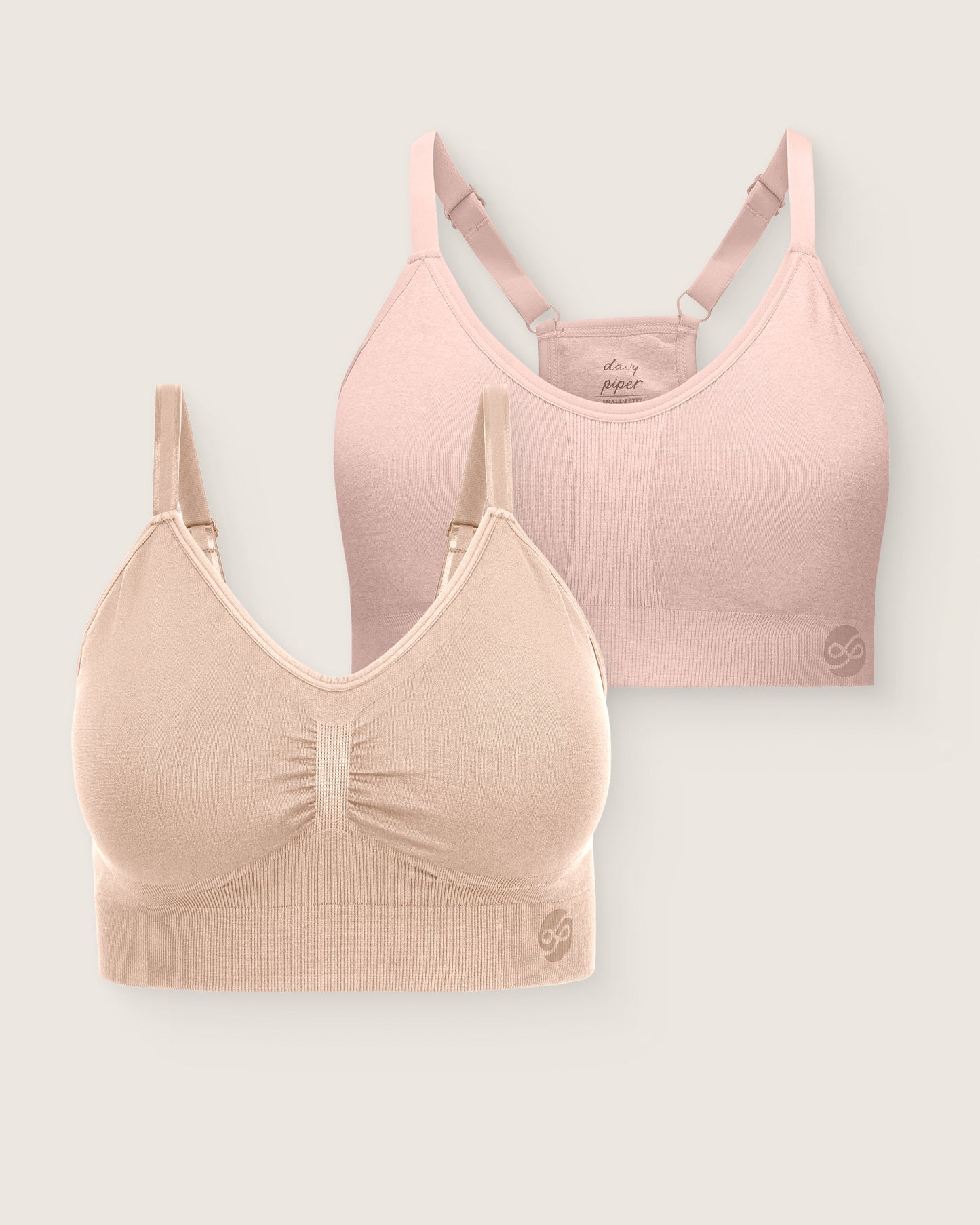 Two bras, one pink and one beige, on a light gray background