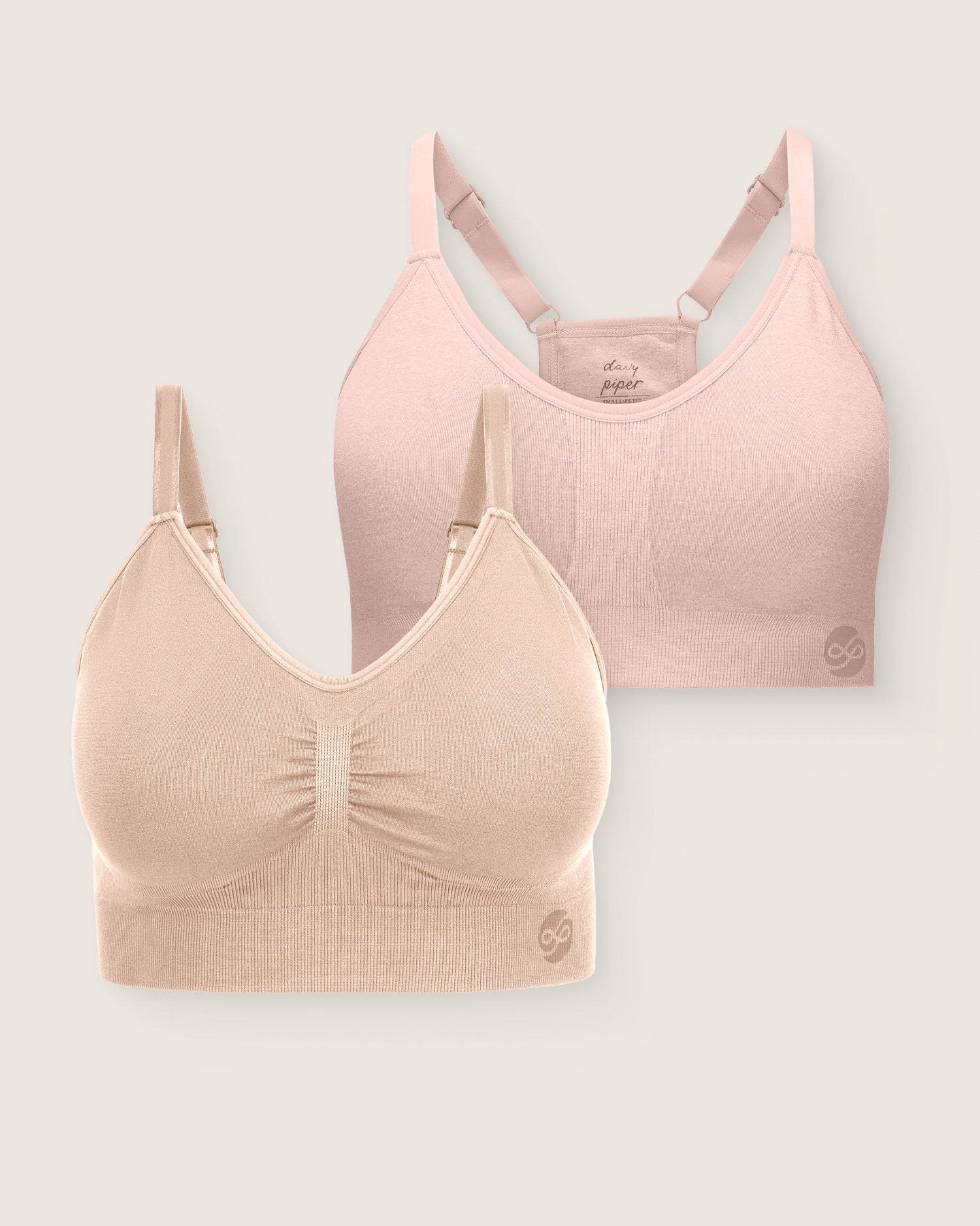 Two bras, one pink and one beige, on a light gray background