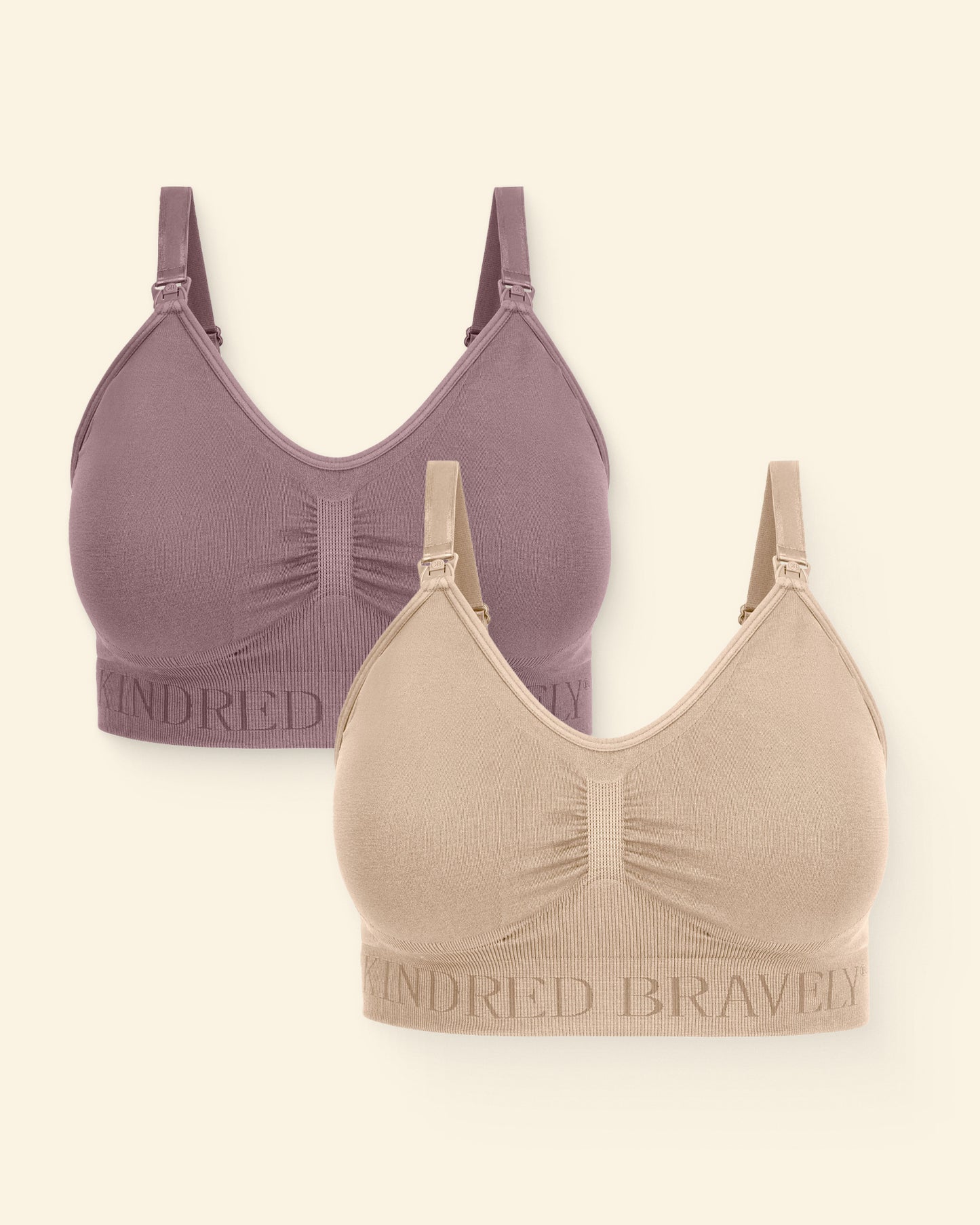 Two bras, one purple and one beige on a beige background.