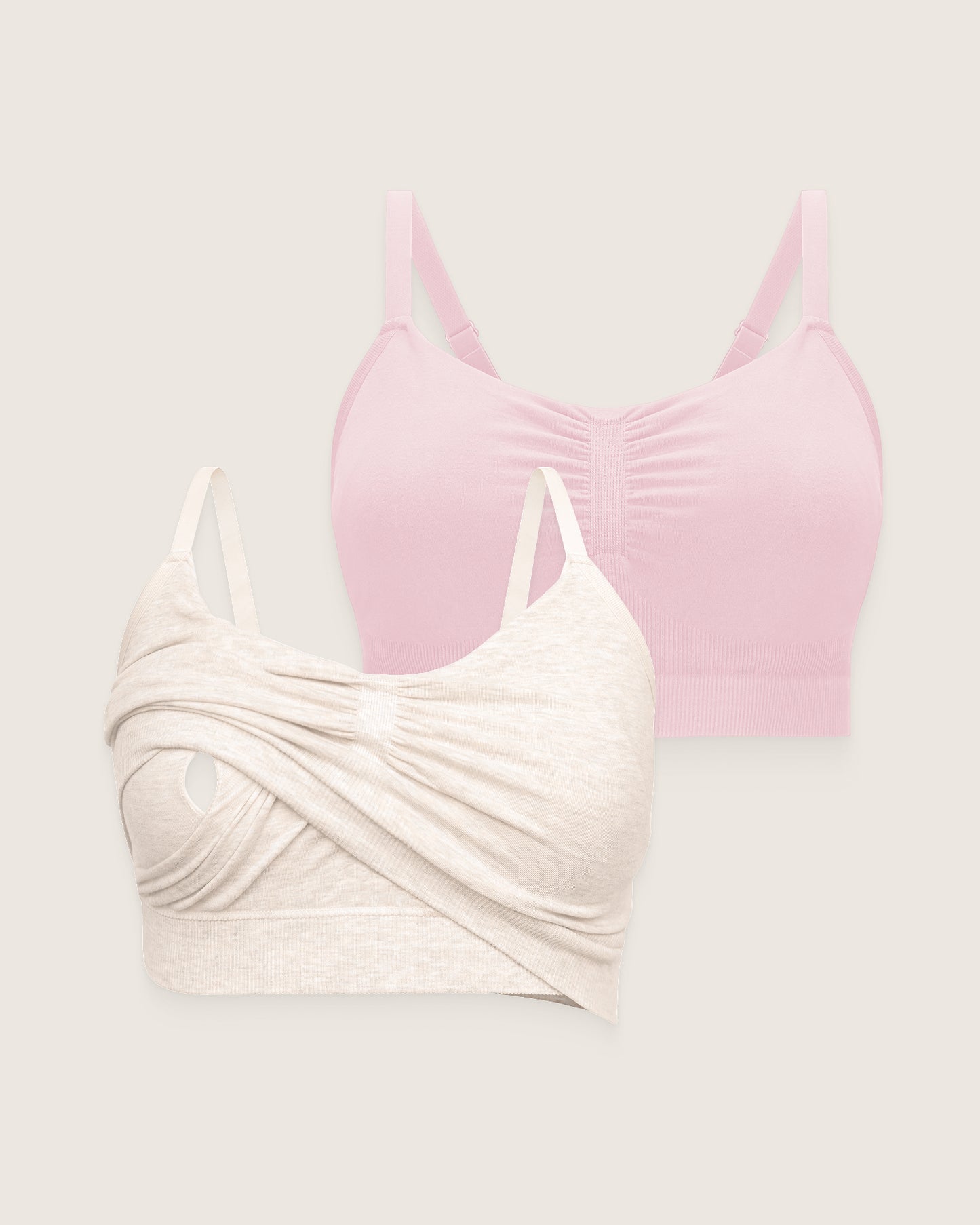 Two bras, one pink and one beige, on a light gray background