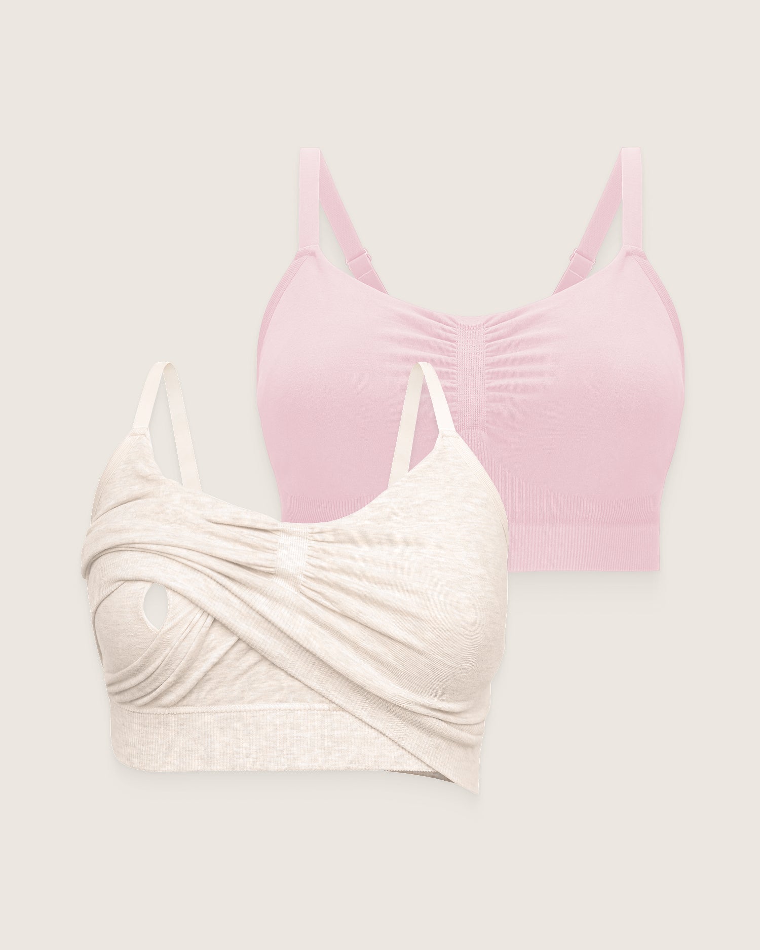 Two bras, one pink and one beige, on a light gray background