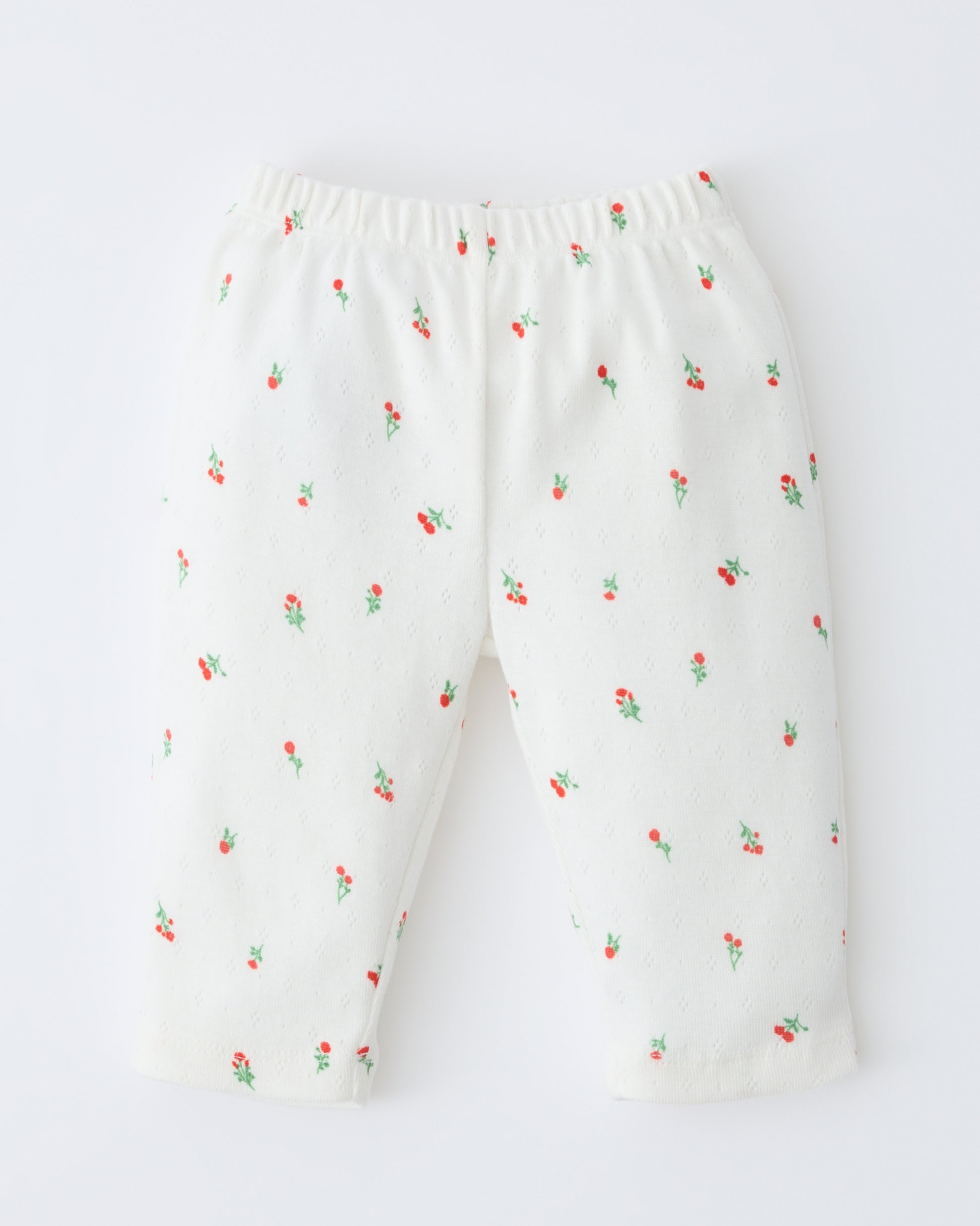Pointelle Leggings in Dainty Ditsy pattern on a beige background.