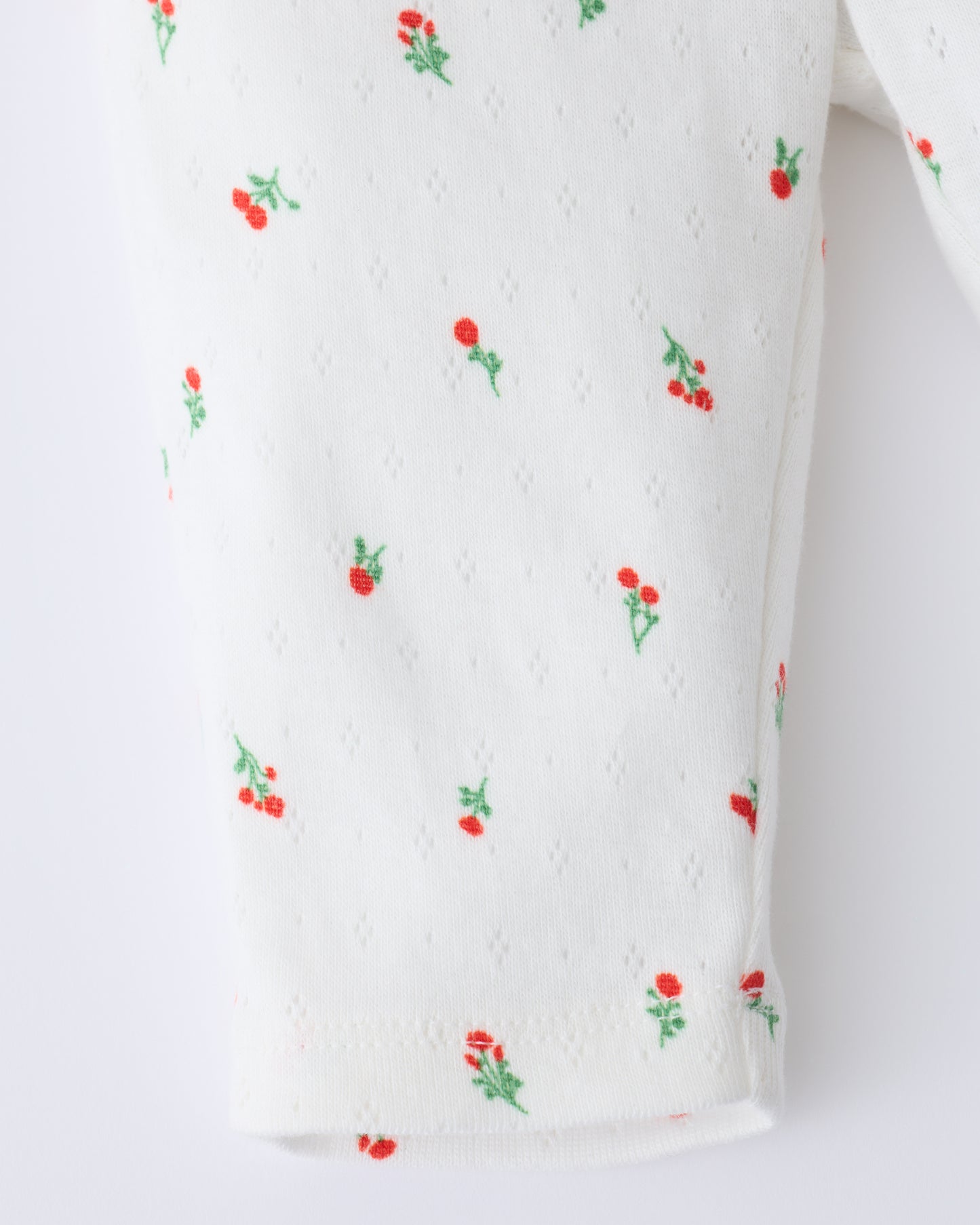 Close up of the leg detail on Pointelle Leggings in Dainty Ditsy pattern on a beige background.