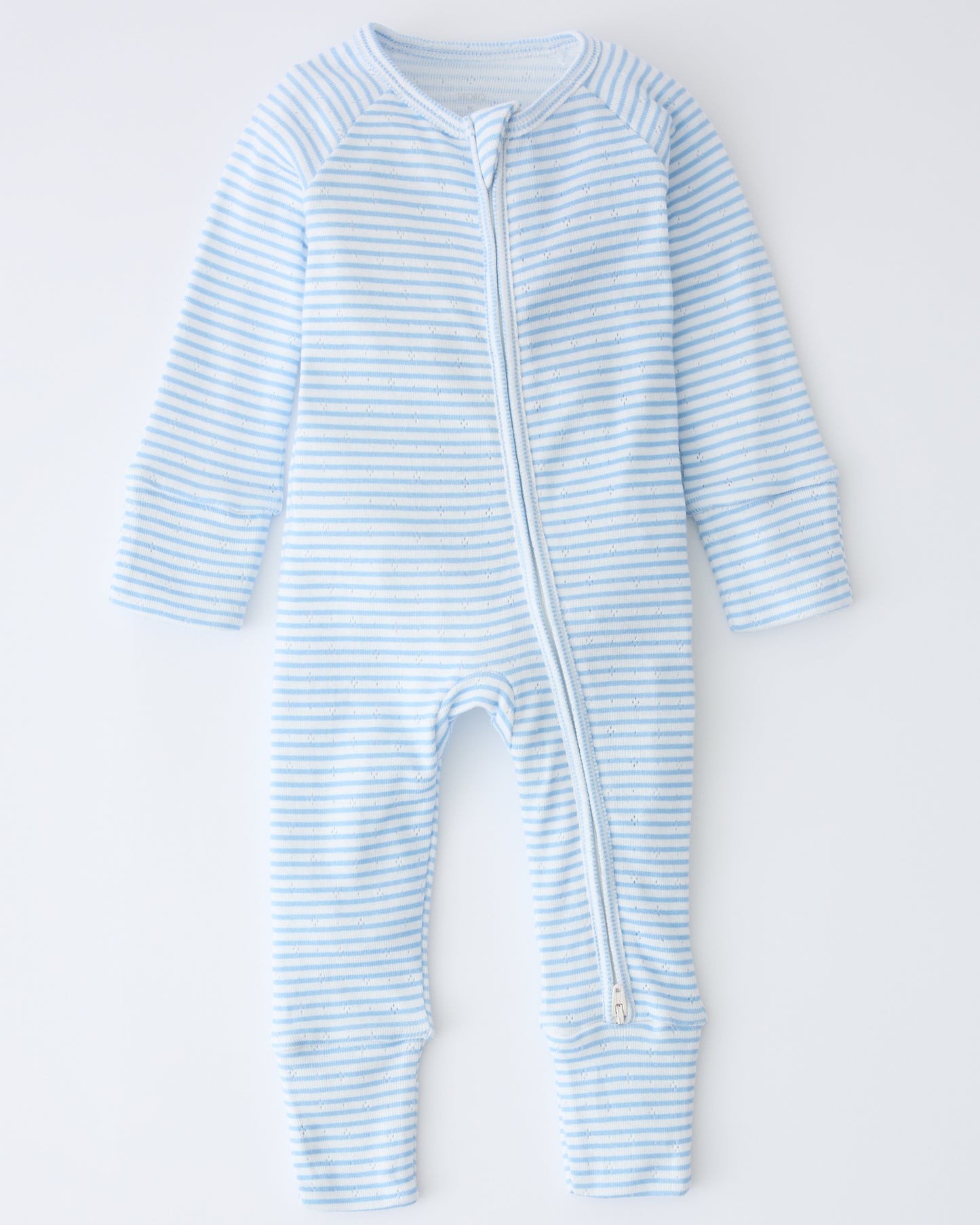 Pointelle Sleeper Pajama in Blue Candy Stripe on a beige background.