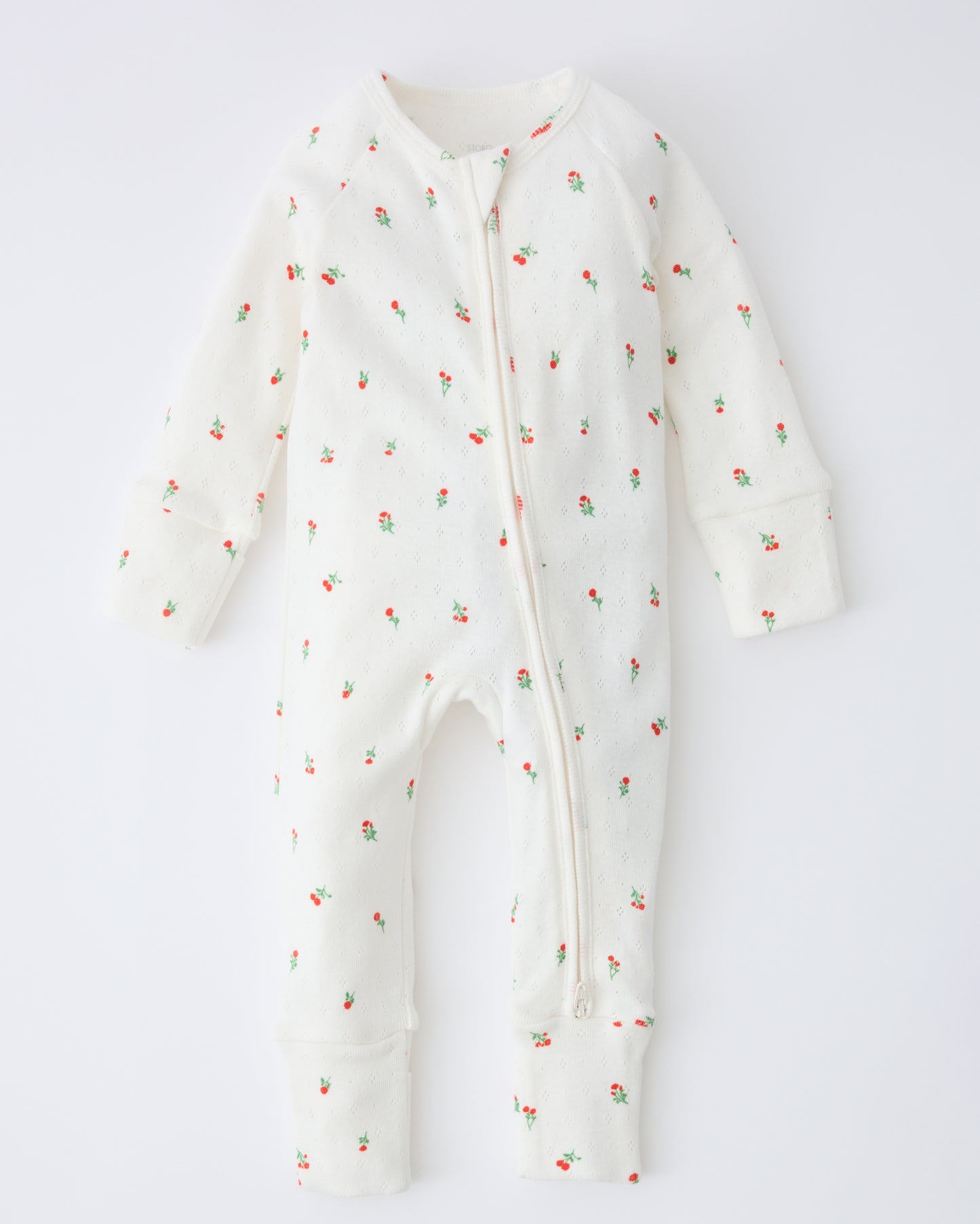 Pointelle Sleeper Pajama in Dainty Ditsy on a beige background.