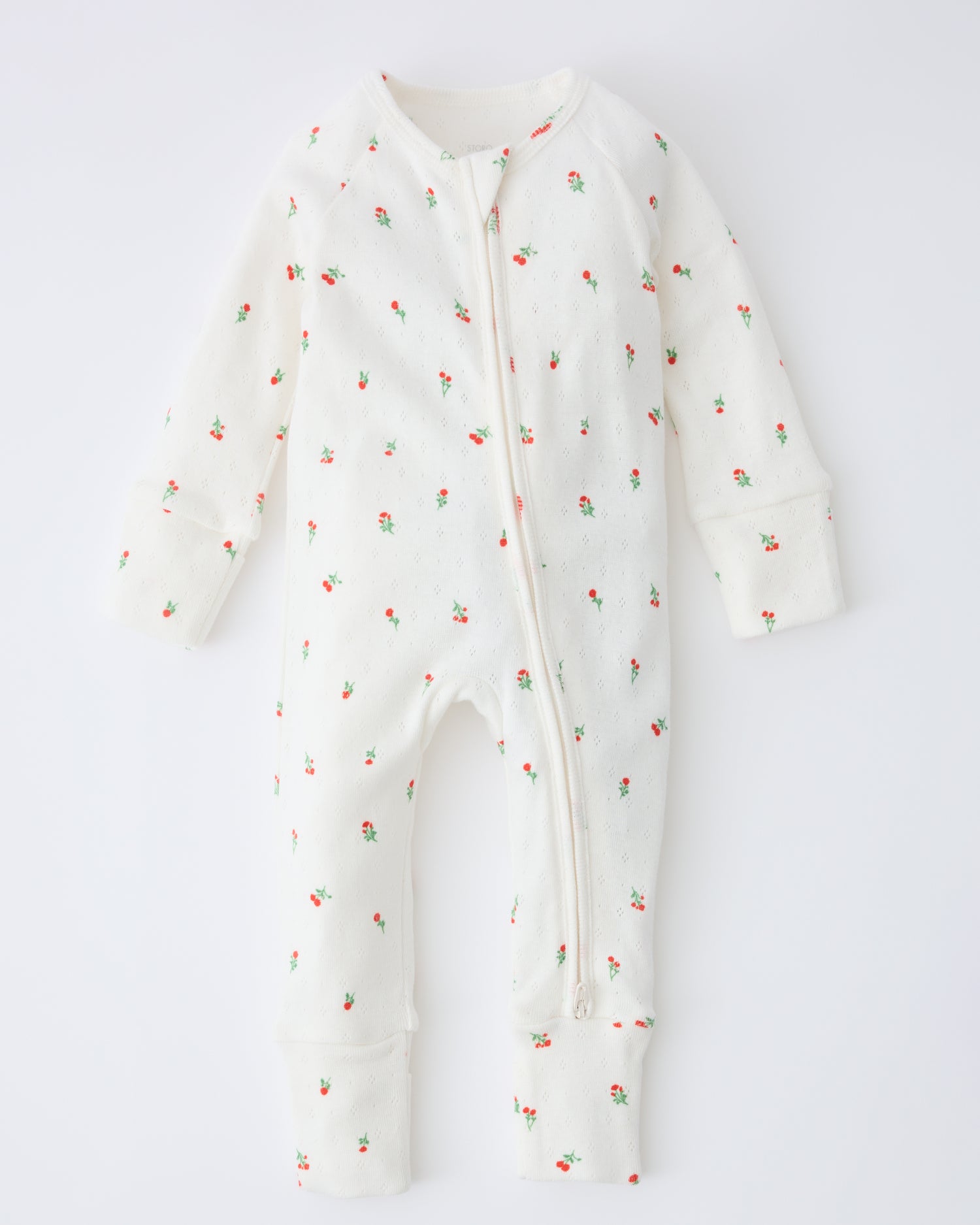 Pointelle Sleeper Pajama in Dainty Ditsy on a beige background.