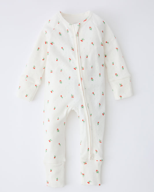Pointelle Sleeper Pajama in Dainty Ditsy on a beige background.