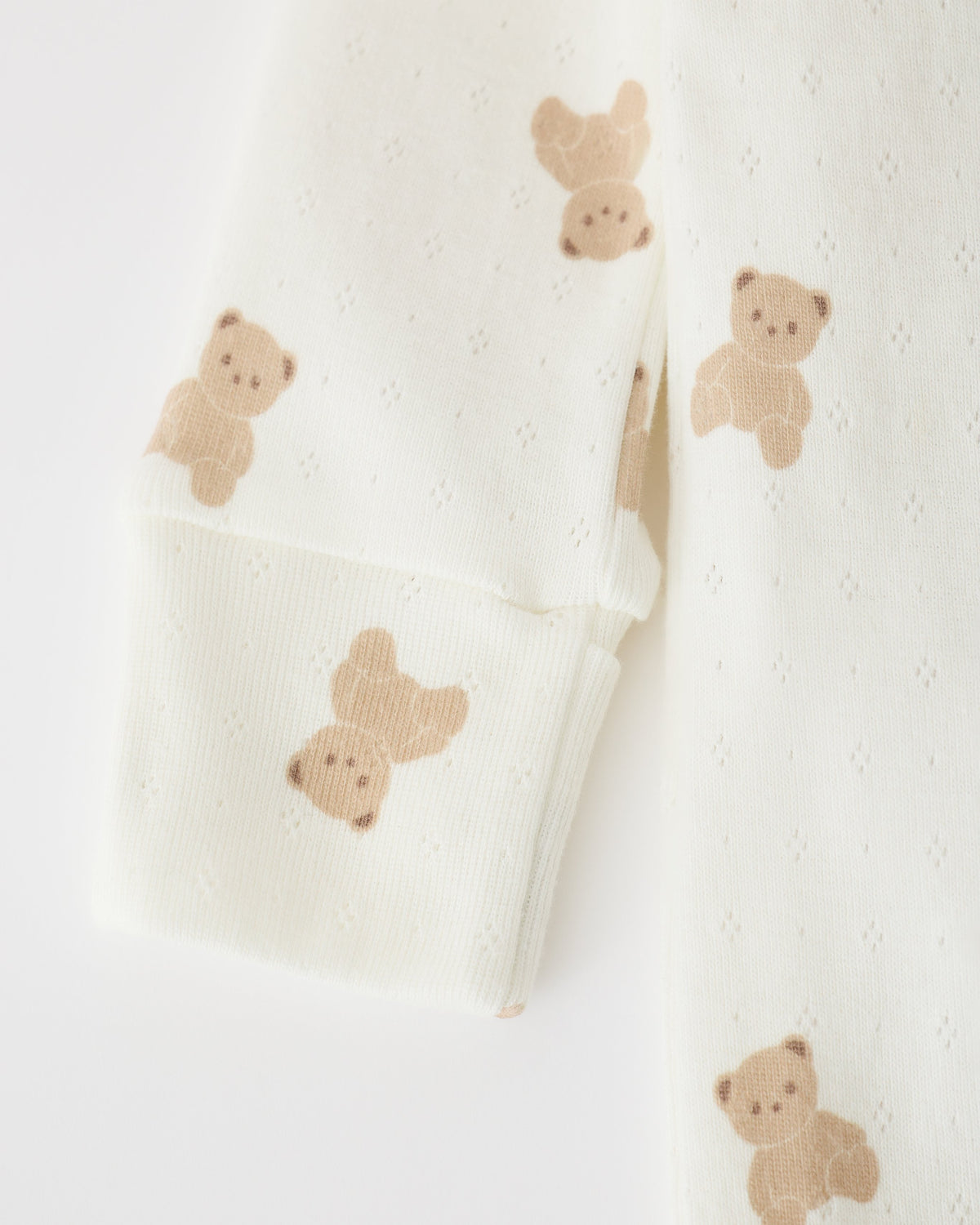 Close up of sleeve detail on Pointelle Baby Pajama in Ivory Bears on an off white background.