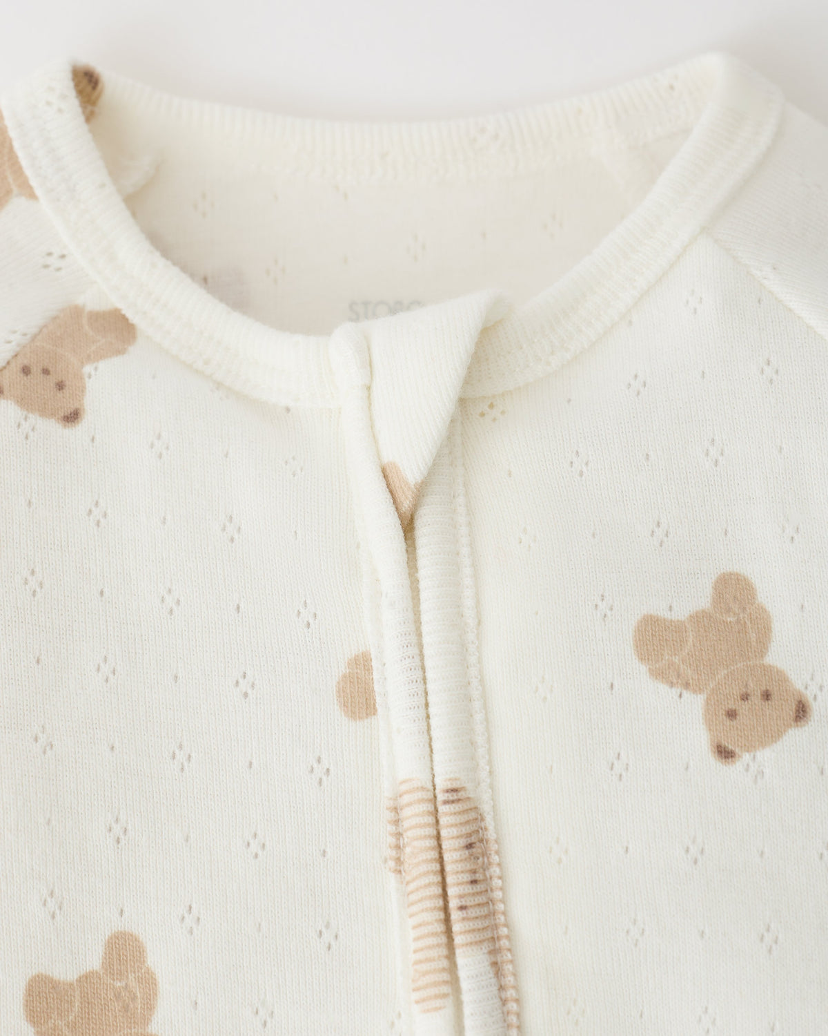 Close up of collar detail on Pointelle Baby Pajama in Ivory Bears on an off white background.