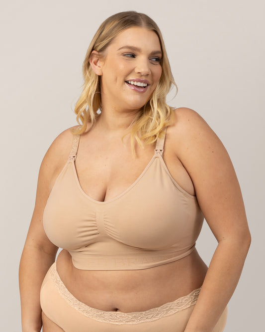Model wearing the Simply Sublime® Nursing Bra in Beige with her hands on her legs. @model_info:Lauren is wearing a 1X Busty.