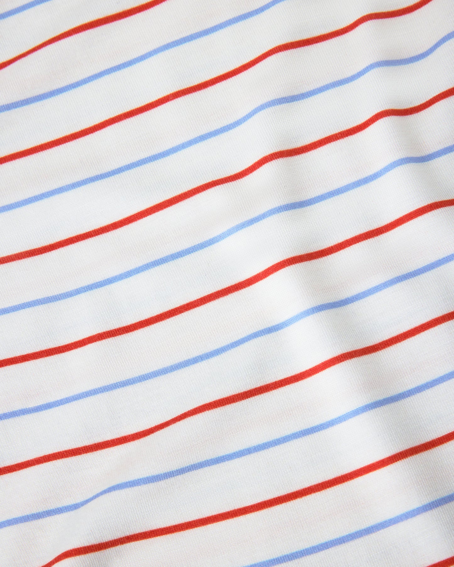 Close up of pattern on Baby Onesie Two-Pack in Milk Please on a beige background