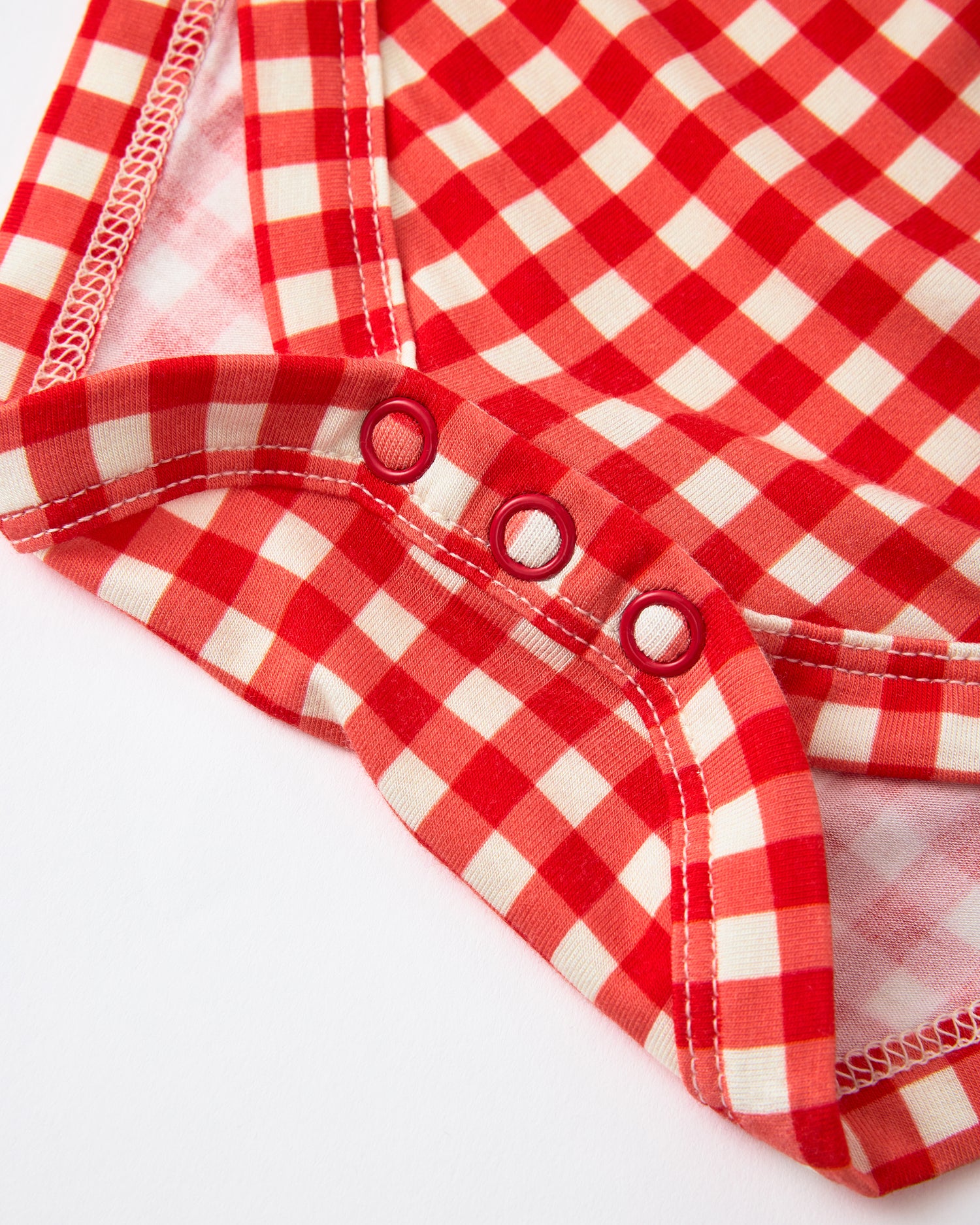 Close up of snaps on Baby Onesie Two-Pack in Red & Blue Gingham