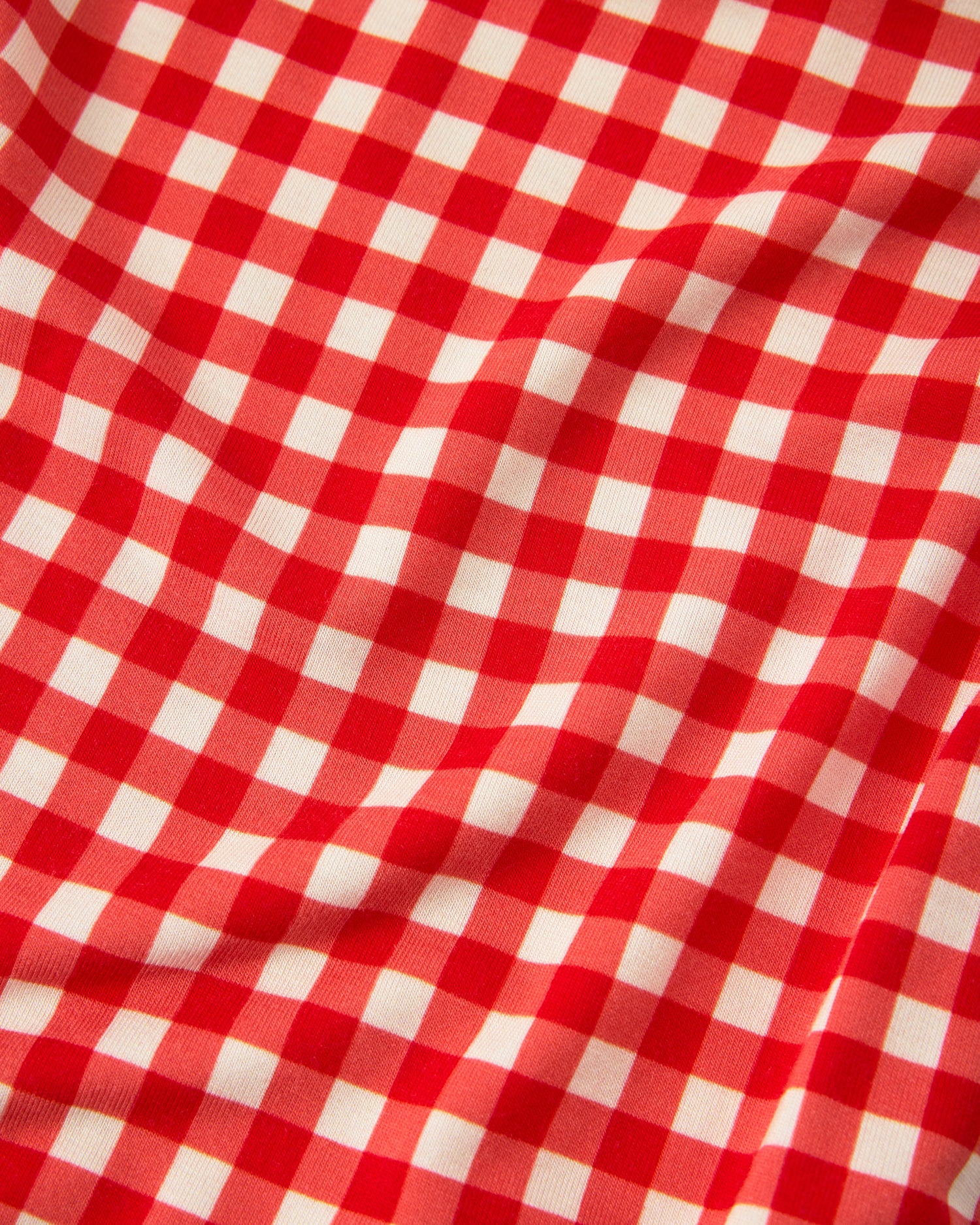 Close up of red pattern on Baby Onesie Two-Pack in Red & Blue Gingham