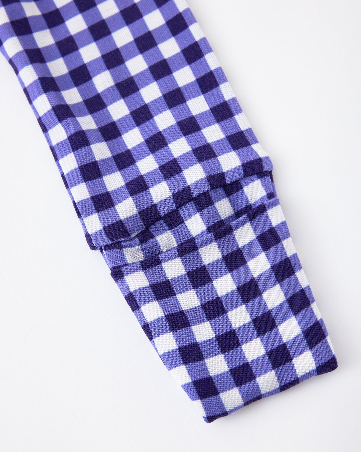 Close up of sleeve detail of Bamboo Baby Pajama in Blue Gingham on a beige background