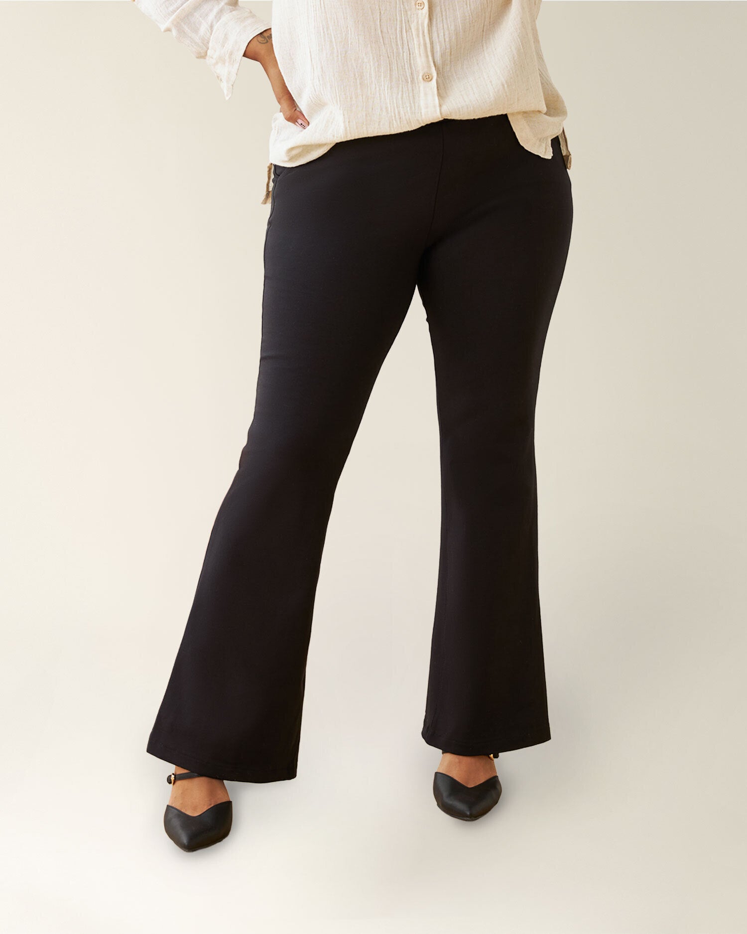 Person wearing Postpartum Ponte Flare Pants on a white background @model_info:Lily is 5'5" and wearing a Large.