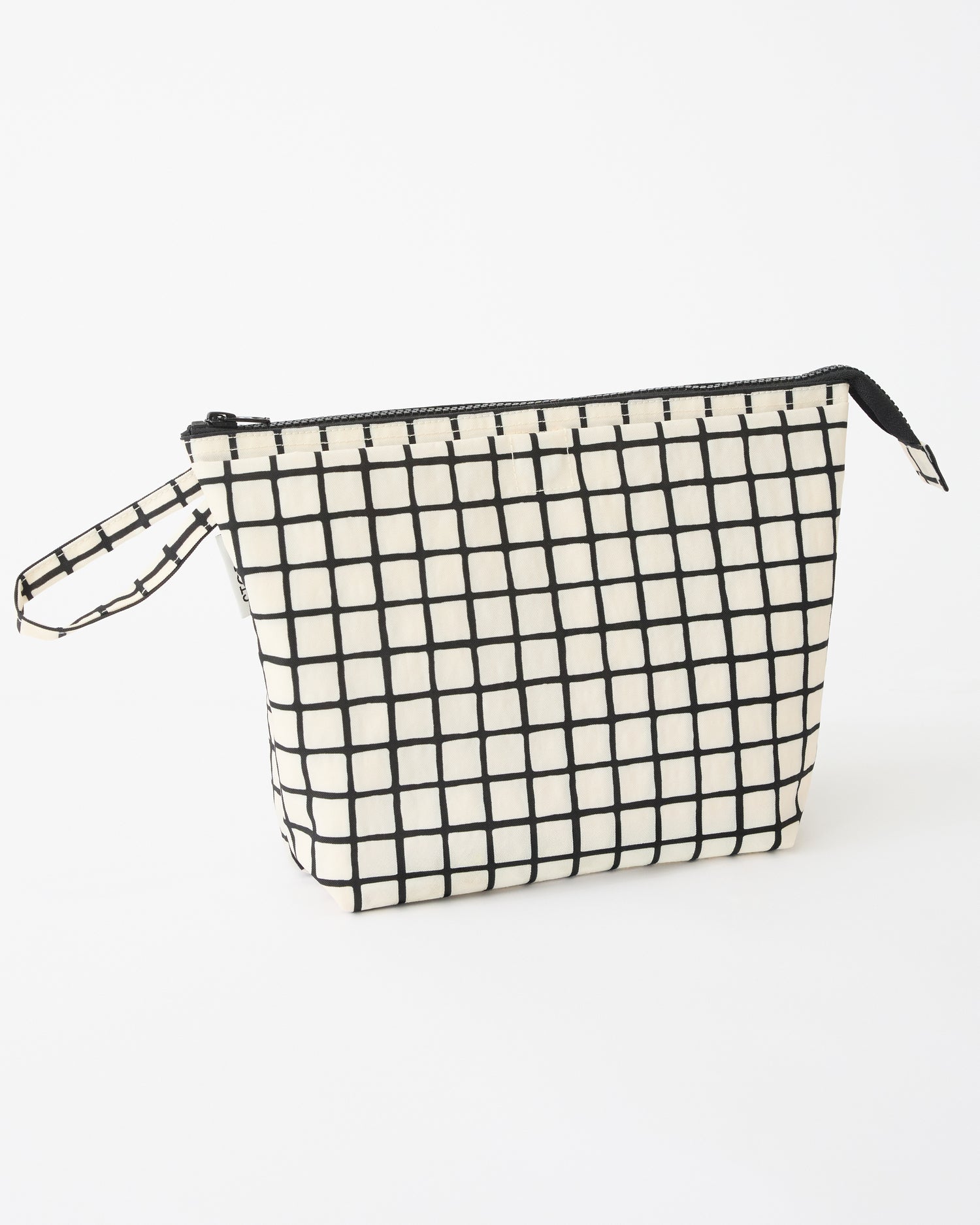 Quick Change Kit Bag in Black Grid on a beige background.